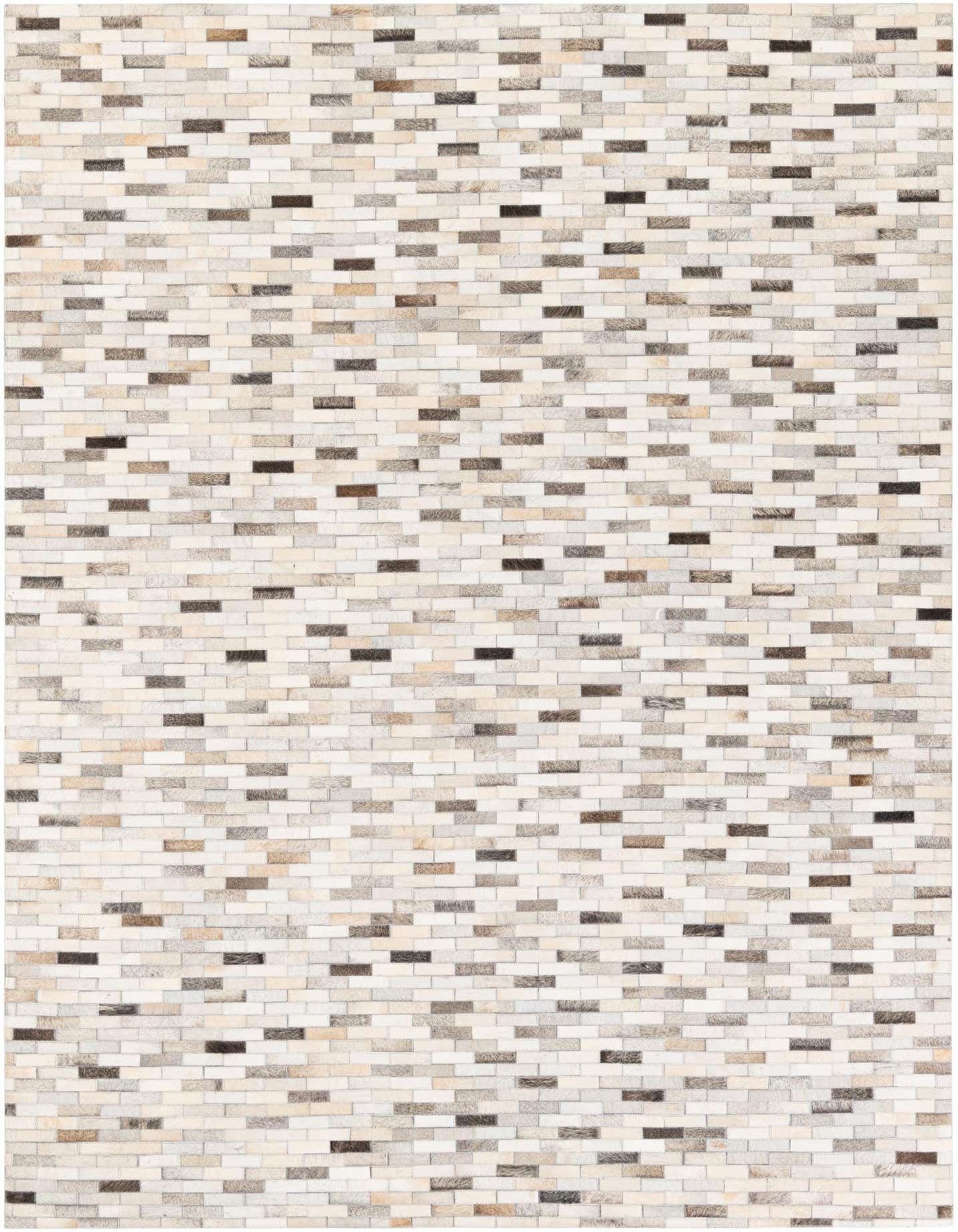 A 5x8 rectangular Cowhide Stocks rug from Rugs.com, featuring a modern patchwork of multi-colored cowhide and leather rectangles in varying shades of light brown, grey, and dark brown.