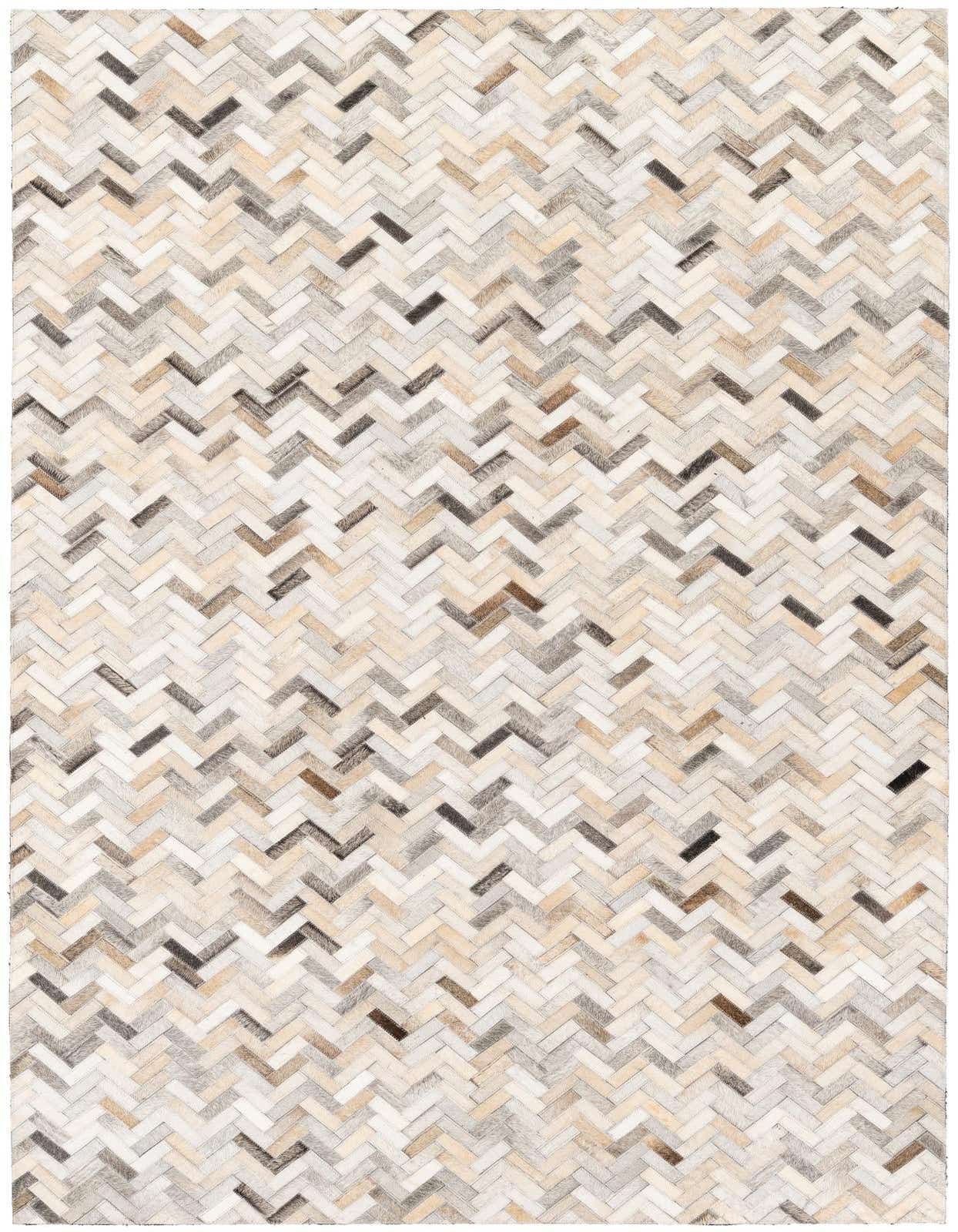 A rectangular 5x8 multi-colored cowhide rug with a modern herringbone stripe pattern, perfect for a living room.