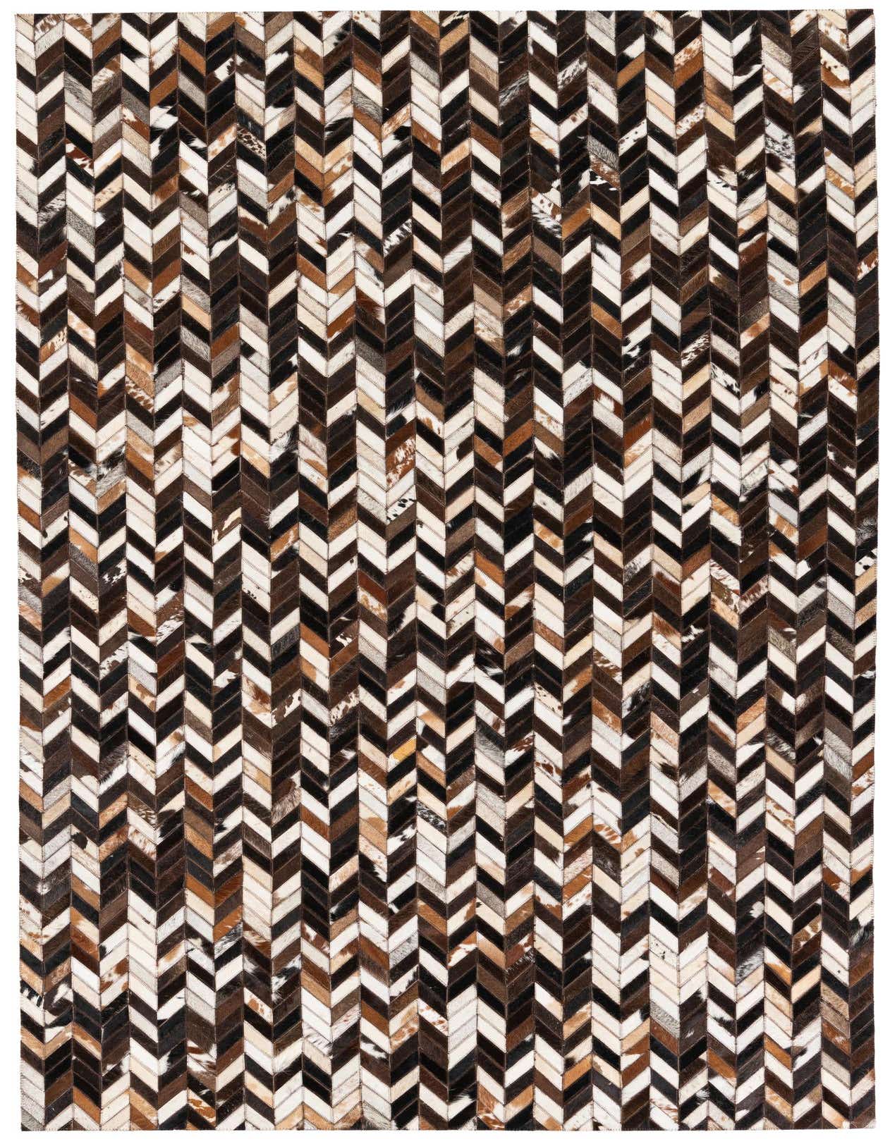 A rectangular 5x8 multi-colored cowhide patchwork rug featuring a geometric chevron pattern in various shades of brown, black, and white.
