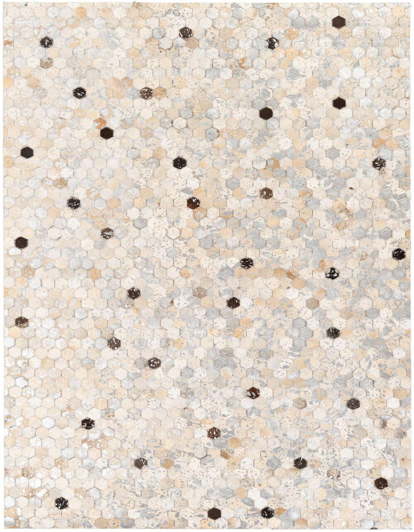 A rectangular 5x8 modern multi-colored cowhide rug featuring a mosaic of hexagonal patches in varying shades of cream, beige, and gray, with scattered darker brown hexagons.