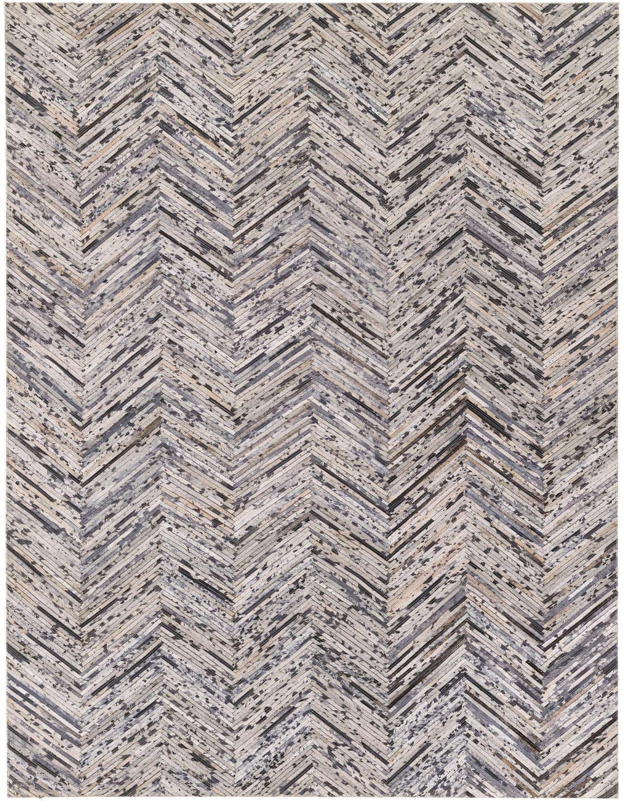 A 5x8 rectangular Cowhide Stocks rug featuring a modern multi-colored chevron pattern with varying shades of grey, black, and natural tones.