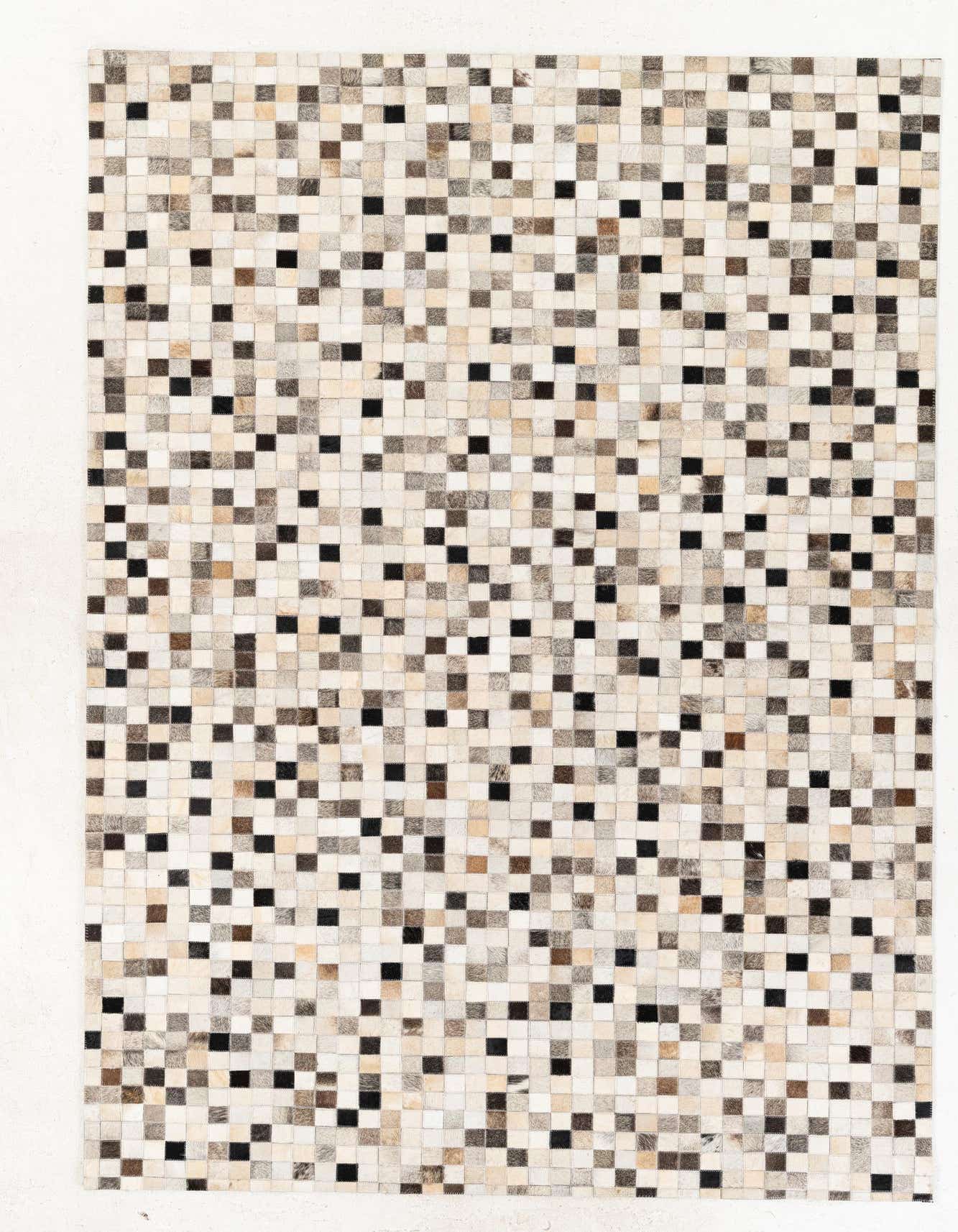 A 5x8 rectangular Cowhide Stocks rug by Rugs.com, featuring a modern patchwork of multi-colored cowhide squares in various shades of brown, black, and cream.