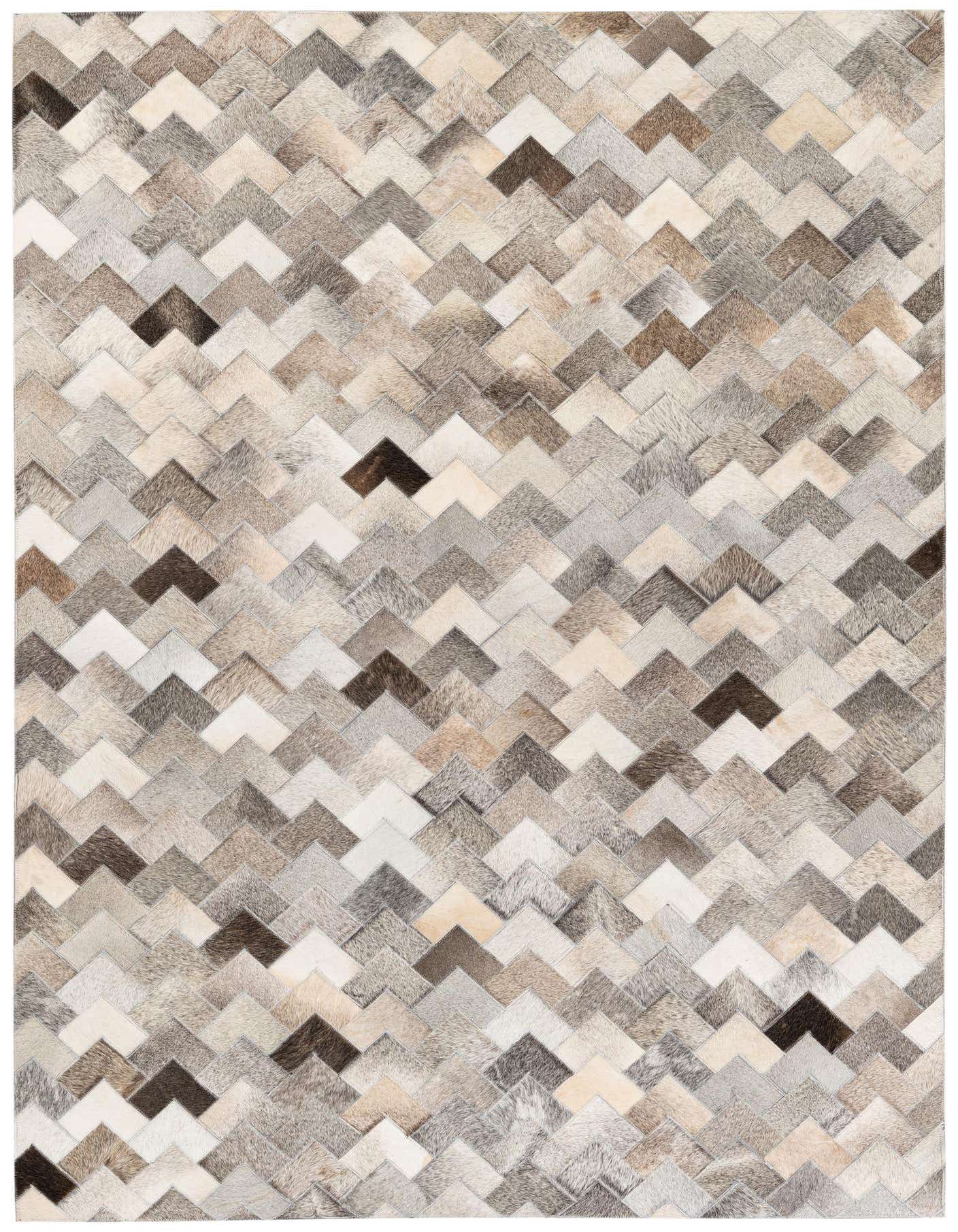 A 5x7 rectangular modern cowhide rug with a multi-colored chevron pattern in shades of brown, beige, and gray.