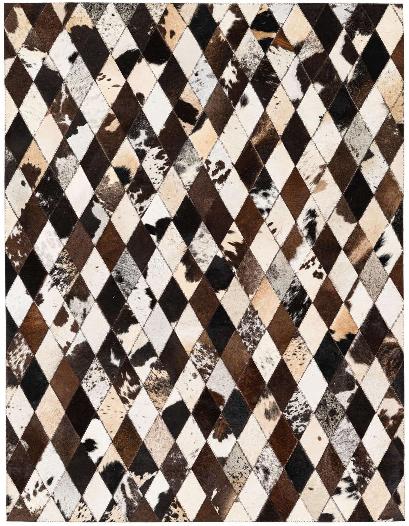 A 4x6 rectangular patchwork cowhide rug with a geometric diamond pattern in varying shades of brown, black, and white.