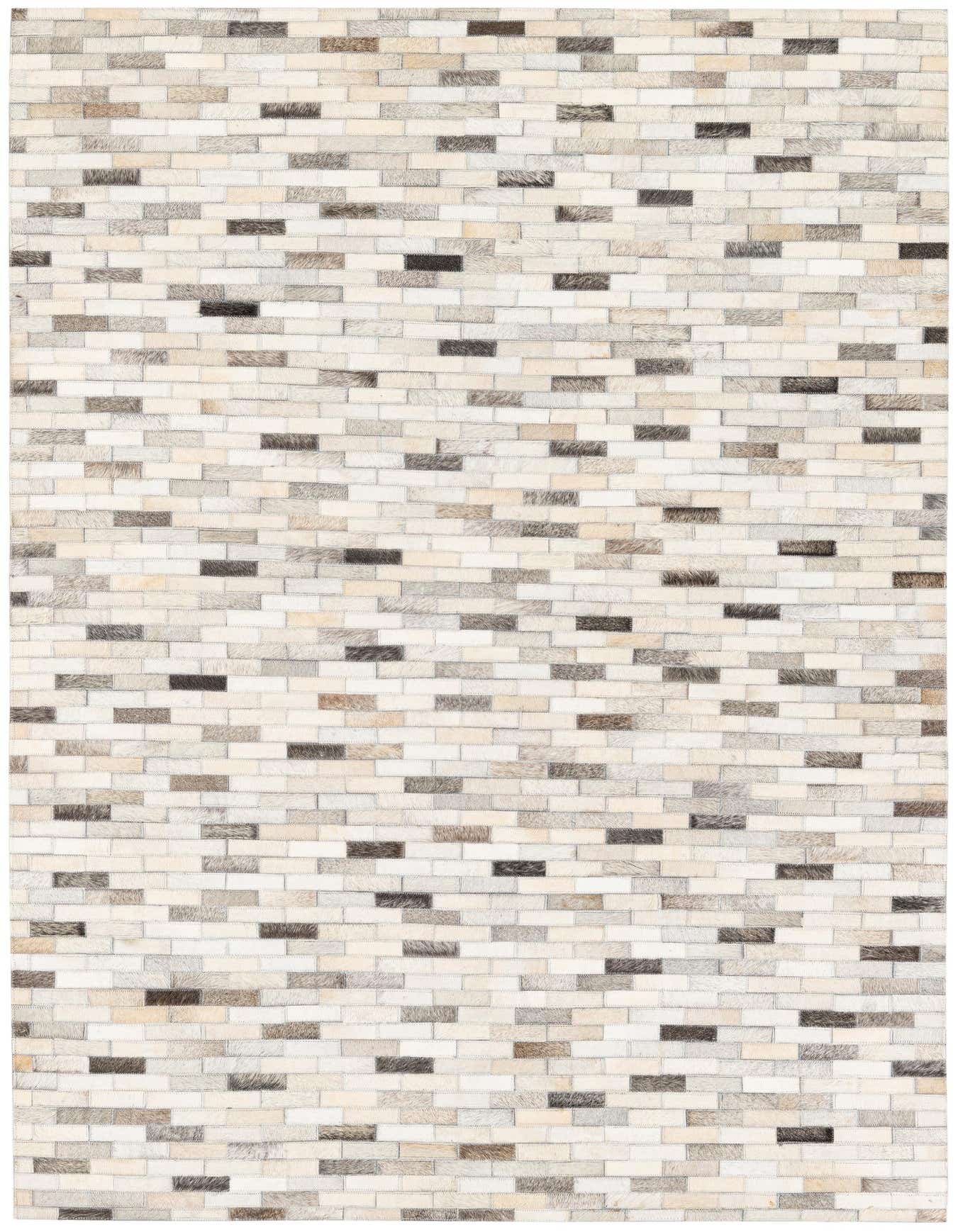 A rectangular 4x6 modern cowhide rug featuring a multi-colored patchwork pattern of light and dark brown, grey, and cream rectangular pieces.
