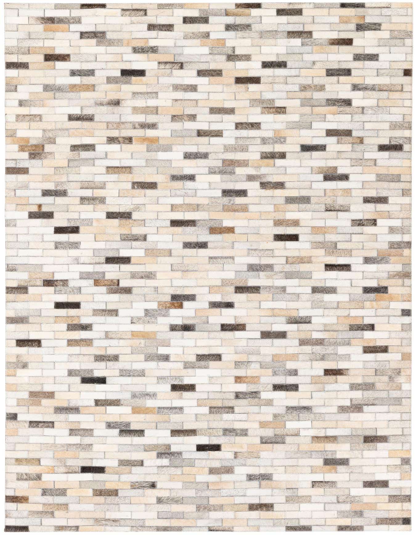 A 4x6 rectangular patchwork cowhide rug featuring varying shades of brown, beige, cream, and black rectangular patches.