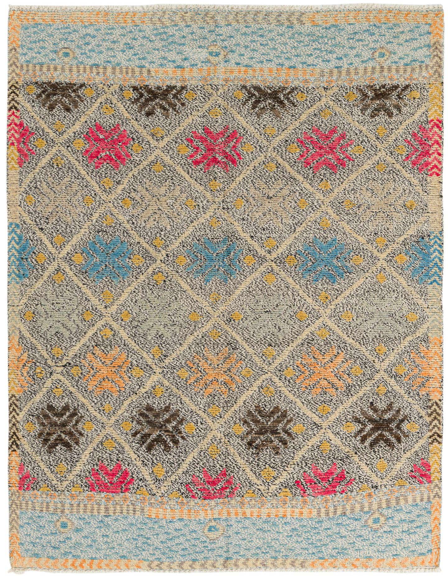 A 5x8 multi-colored rectangular wool rug with a modern abstract pattern, featuring diamonds and floral motifs.