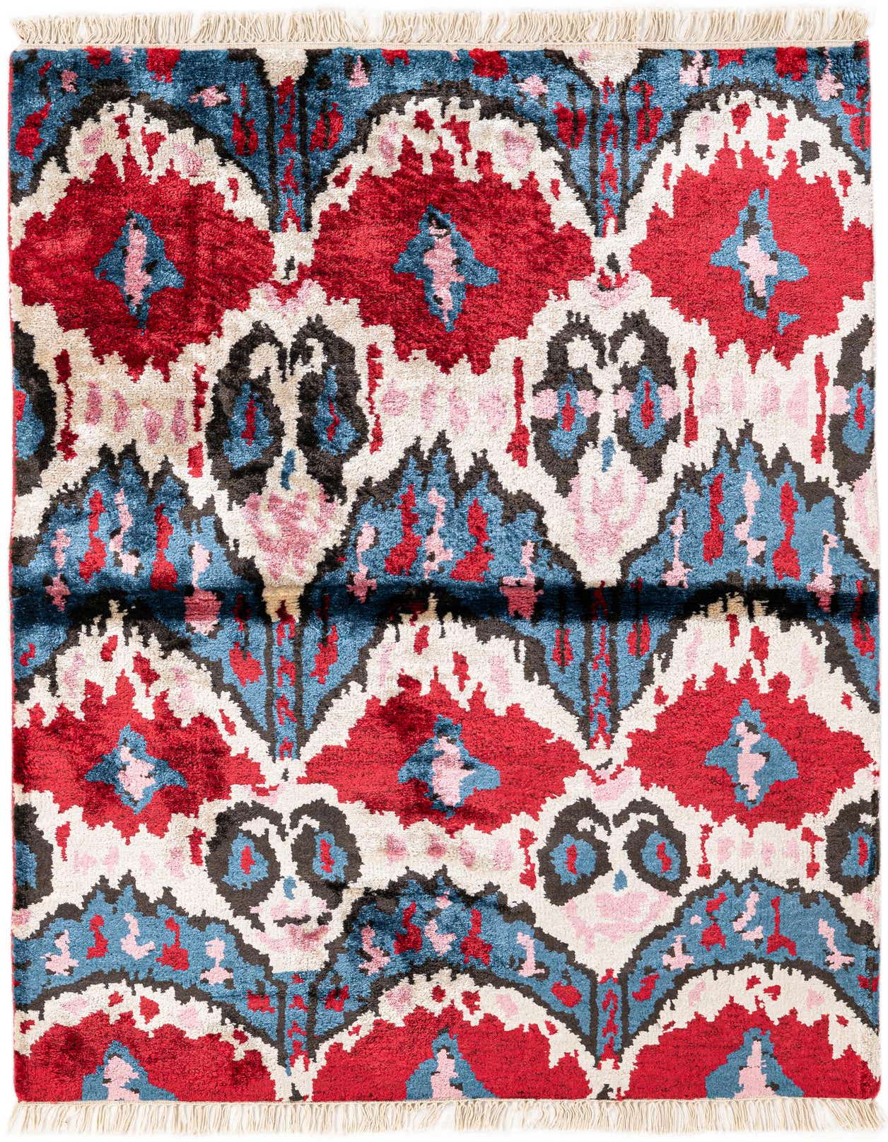 A 3x5 rectangular multi-colored wool rug with a modern ikat pattern in red, blue, pink, and black, featuring white fringe.
