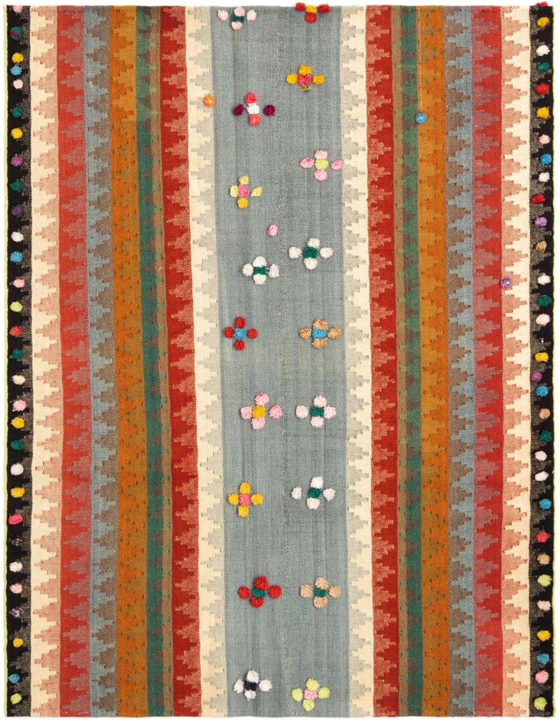 A 4x6 rectangular multi-colored Persian wool rug featuring a central light blue stripe with colorful floral tufts, flanked by striped patterns in red, orange, green, and cream, with black borders adorned with colorful pom-poms.