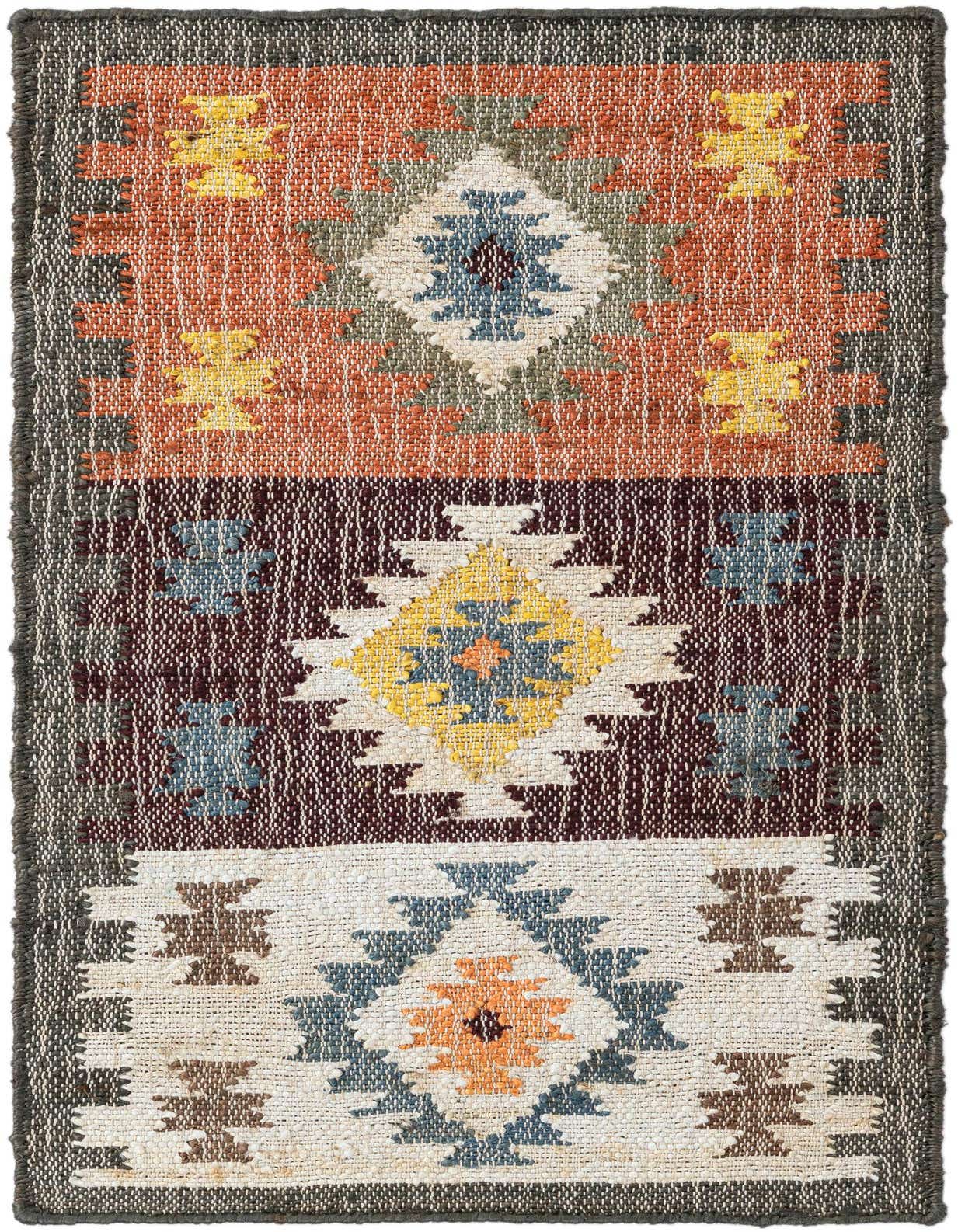A 2x3 multi-colored rectangular rug with a modern geometric pattern, featuring blocks of orange, maroon, and cream with blue, yellow, and brown accents.
