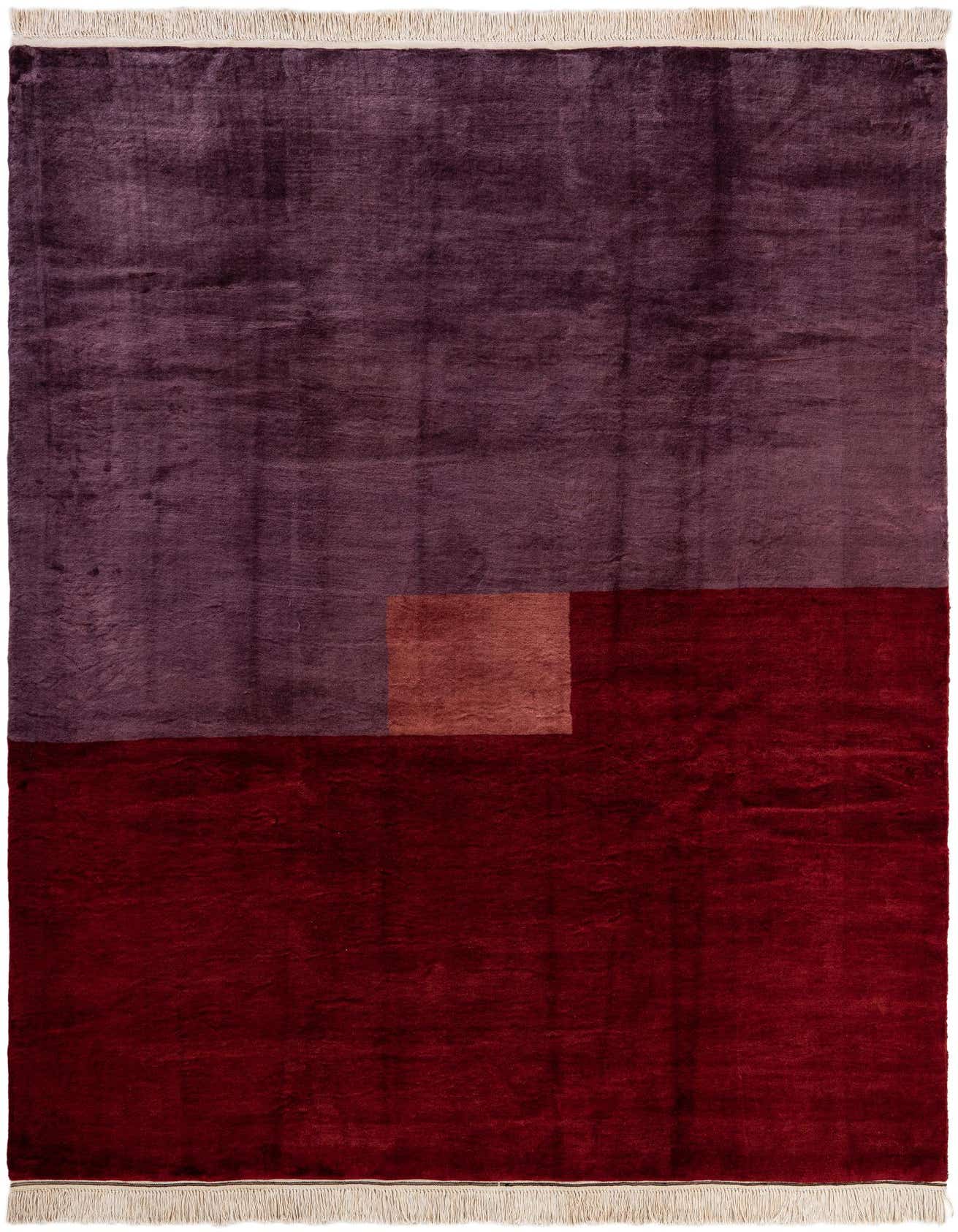 A 6x9 rectangular modern wool rug featuring a color block design with deep purple, rich red, and a smaller rust-colored rectangle.