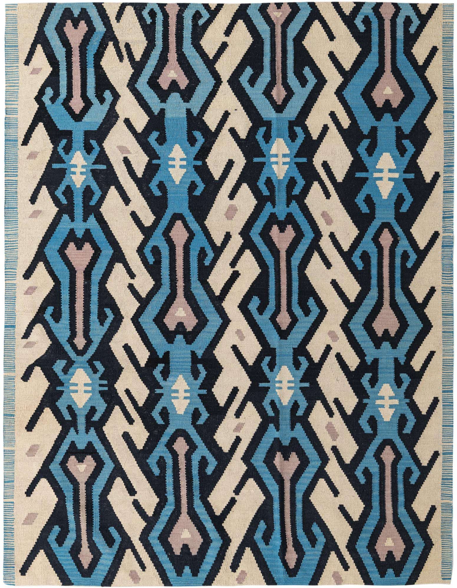 A 6x9 rectangular multi-colored wool flatweave rug with a bold tribal and abstract pattern in shades of blue, black, beige, and light purple.