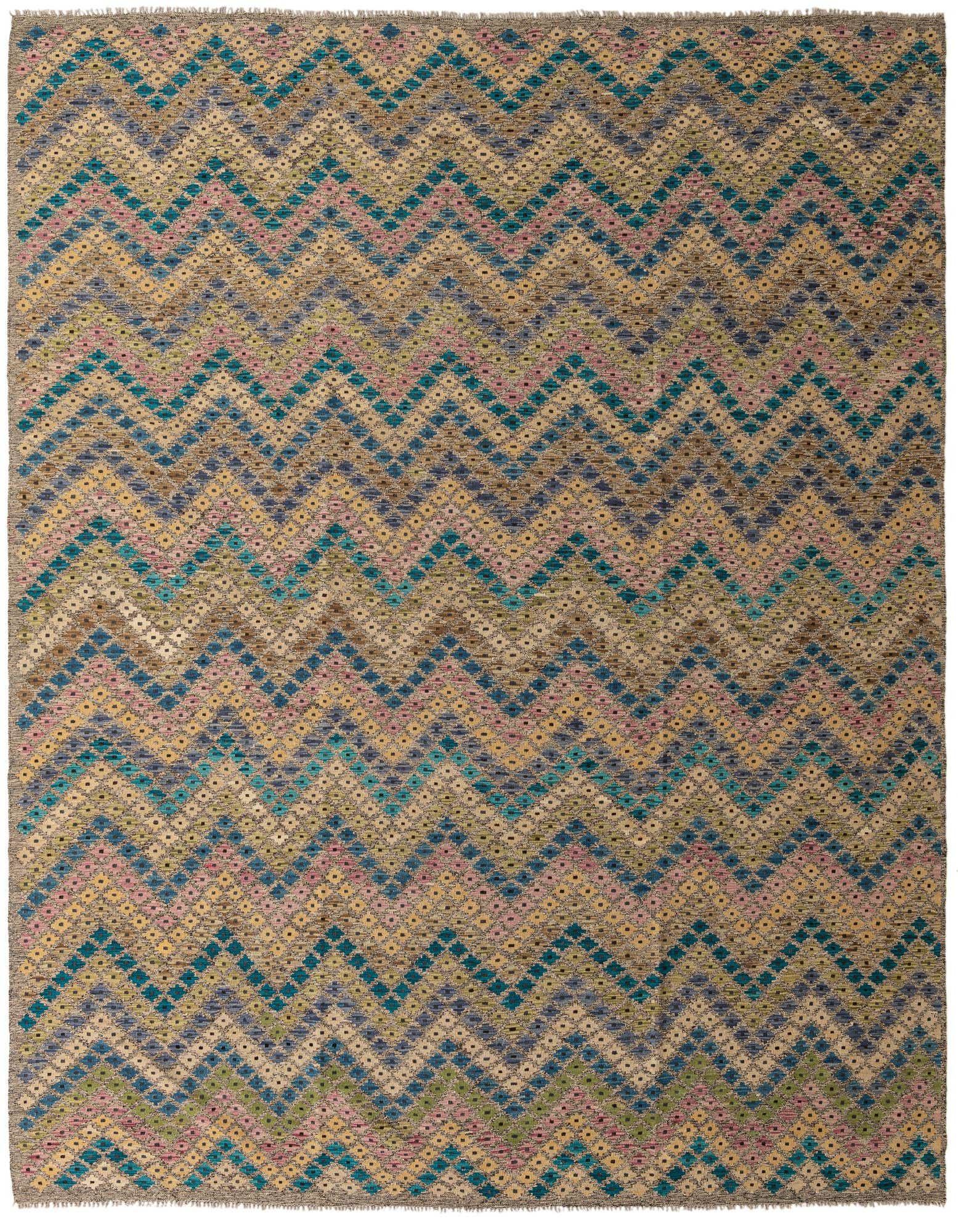 A 10x13 rectangular multi-colored wool rug with a vibrant tribal zigzag pattern in teal, pink, yellow, and brown.
