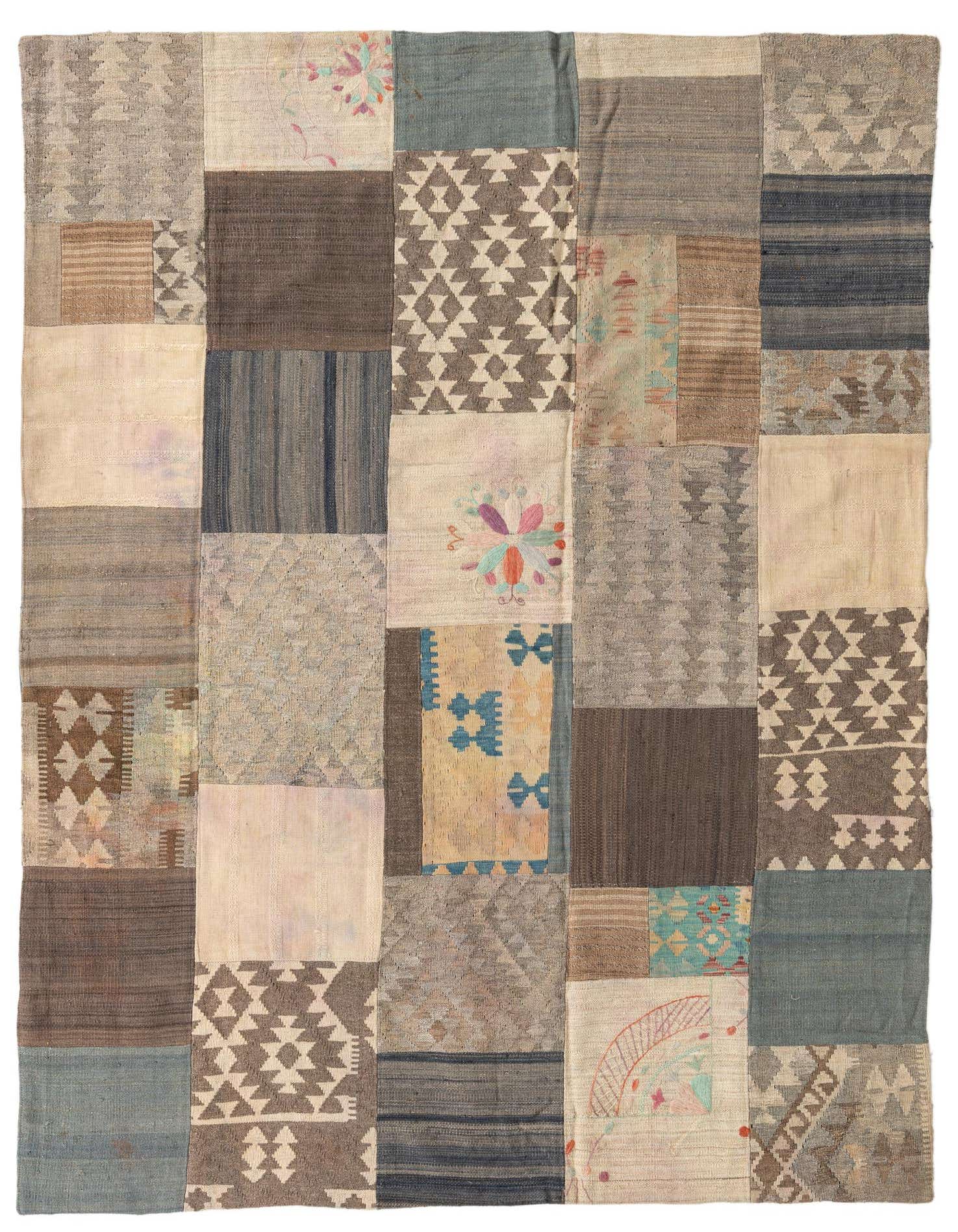 A 6x9 rectangular multi-colored Kilim Patchwork rug, handmade with various Southwestern and tribal patterns in muted tones, ideal for a living room.