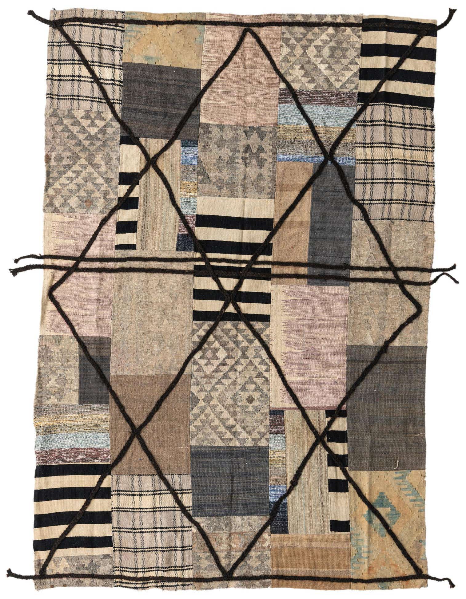 A 5x8 rectangular Kilim Patchwork rug with multi-colored wool patches and a dark tribal grid pattern.
