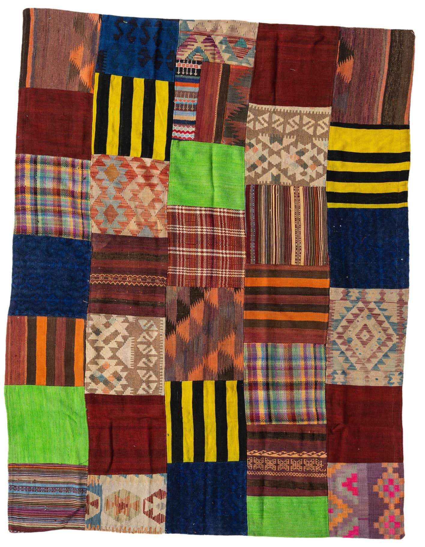 A vibrant 5x8 multi-colored rectangular Kilim Patchwork wool rug featuring various Southwestern and tribal patterns.