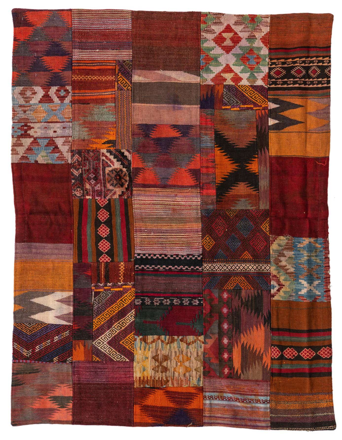 A 4x6 rectangular multi-colored patchwork rug featuring various Southwestern, tribal, and abstract wool flatweave patterns.
