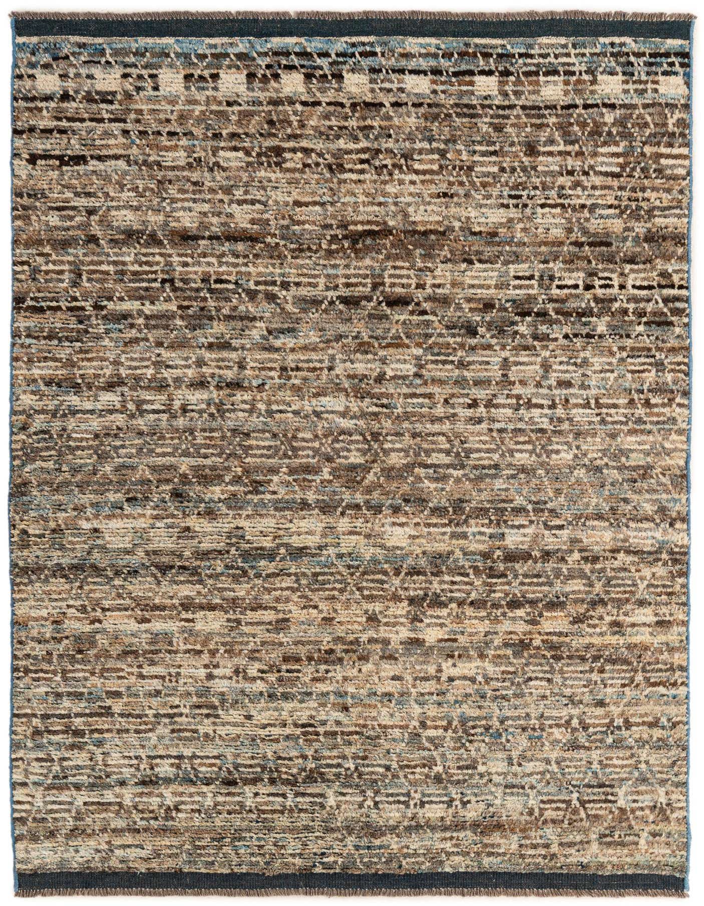 A 5x7 rectangular multi-colored wool rug featuring a tribal, modern, and oriental pattern with shades of brown, beige, and blue.