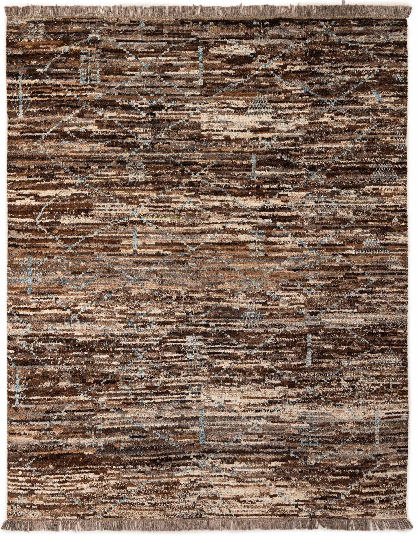 A 6x9 rectangular multi-colored tribal rug with brown, beige, and light blue hues, featuring a modern abstract pattern and fringed edges.
