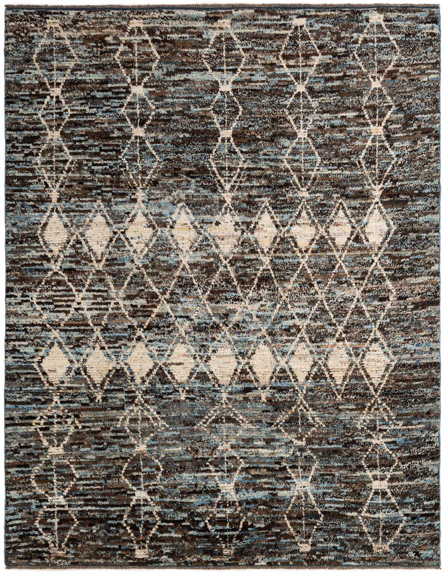 A 6x9 rectangular multi-colored tribal wool rug with a distressed diamond pattern in shades of blue, brown, and cream.
