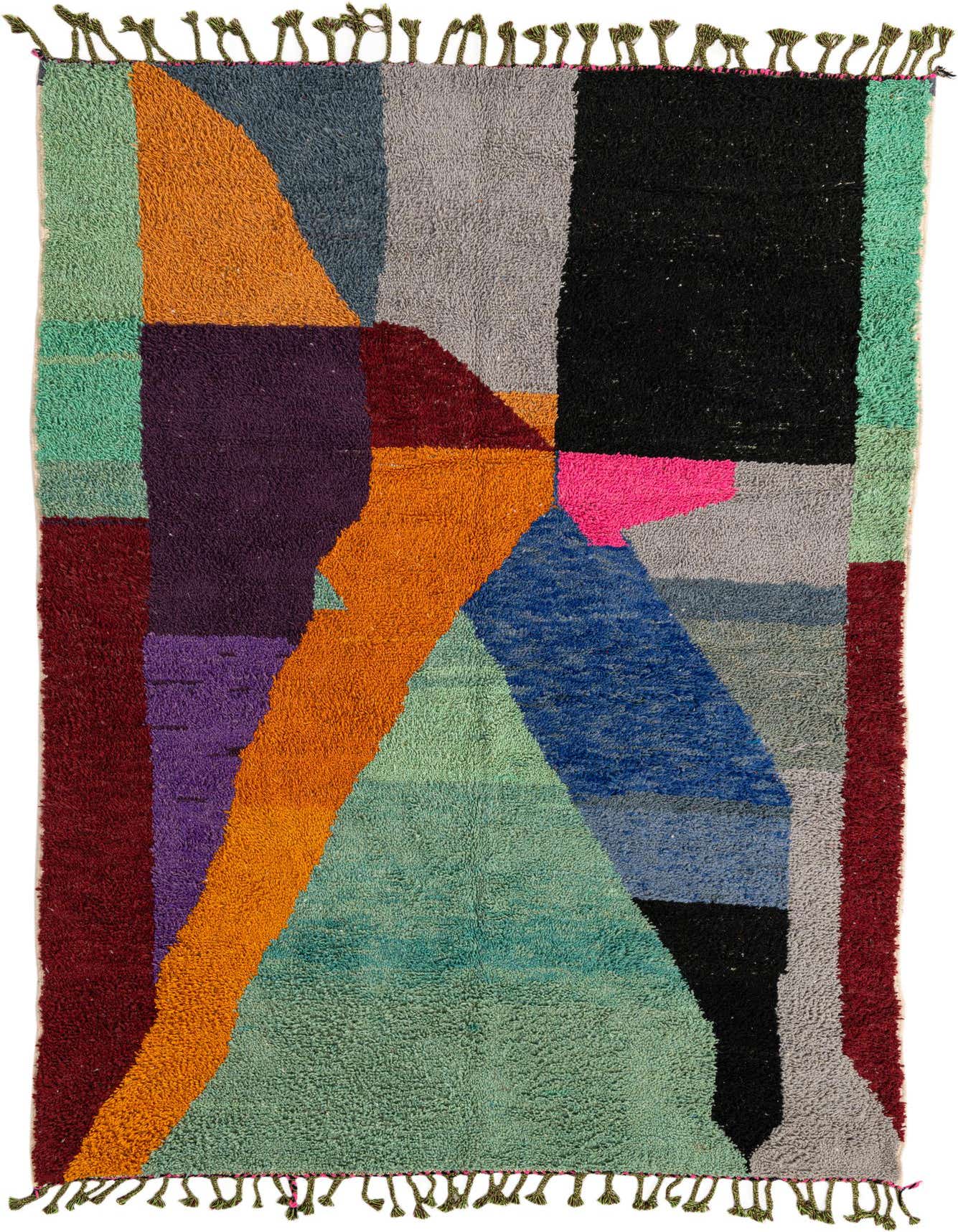 A 6x9 rectangular multi-colored shag rug with an abstract tribal pattern, featuring blocks of green, orange, purple, blue, black, and grey.