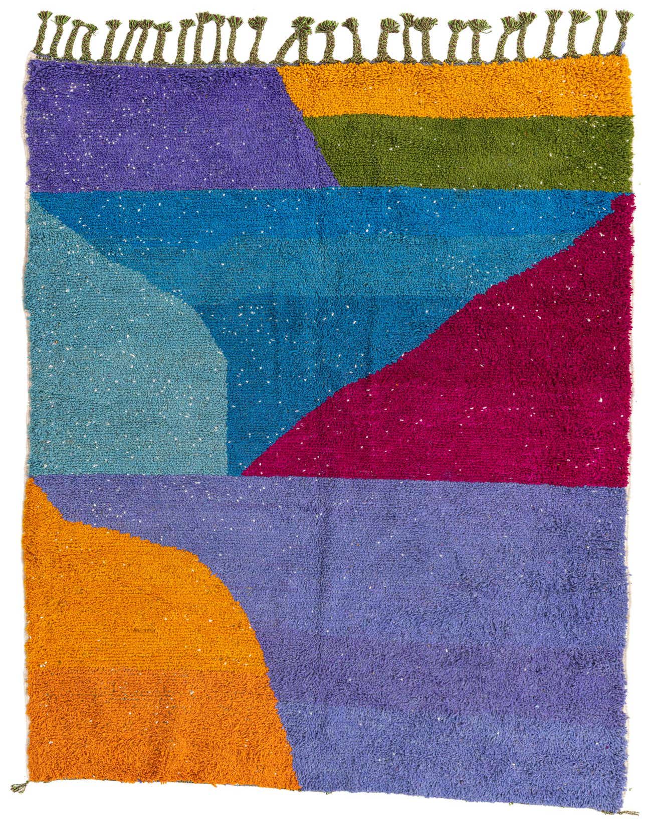 A vibrant 6x9 rectangular shag rug featuring a modern, abstract pattern in bold blocks of purple, blue, teal, magenta, orange, and olive green, with decorative tassels along one edge.