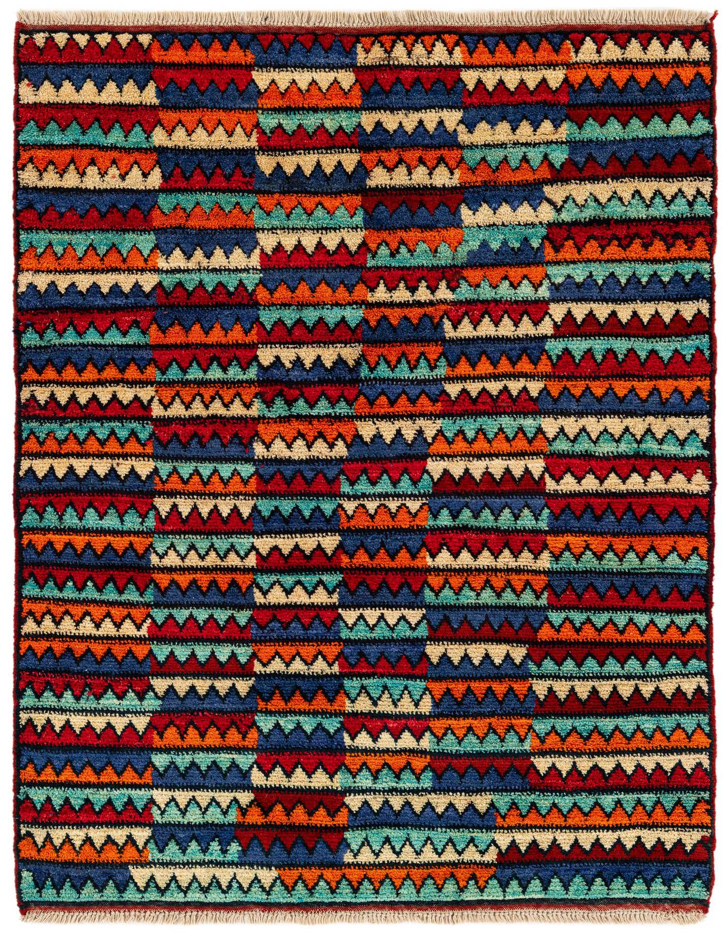 A 4x6 multi-colored rectangular shag rug featuring a vibrant tribal geometric pattern of triangles and stripes.