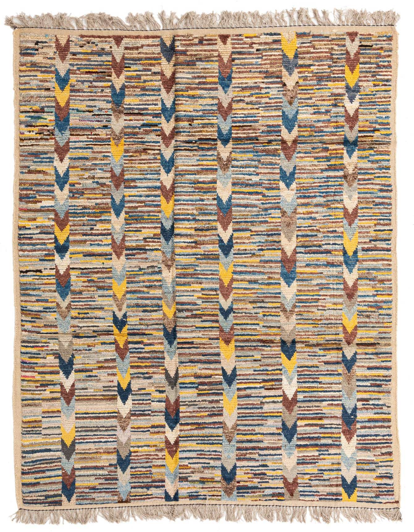 A 6x9 rectangular multi-colored wool shag rug with vertical tribal chevron patterns in blue, yellow, and brown.
