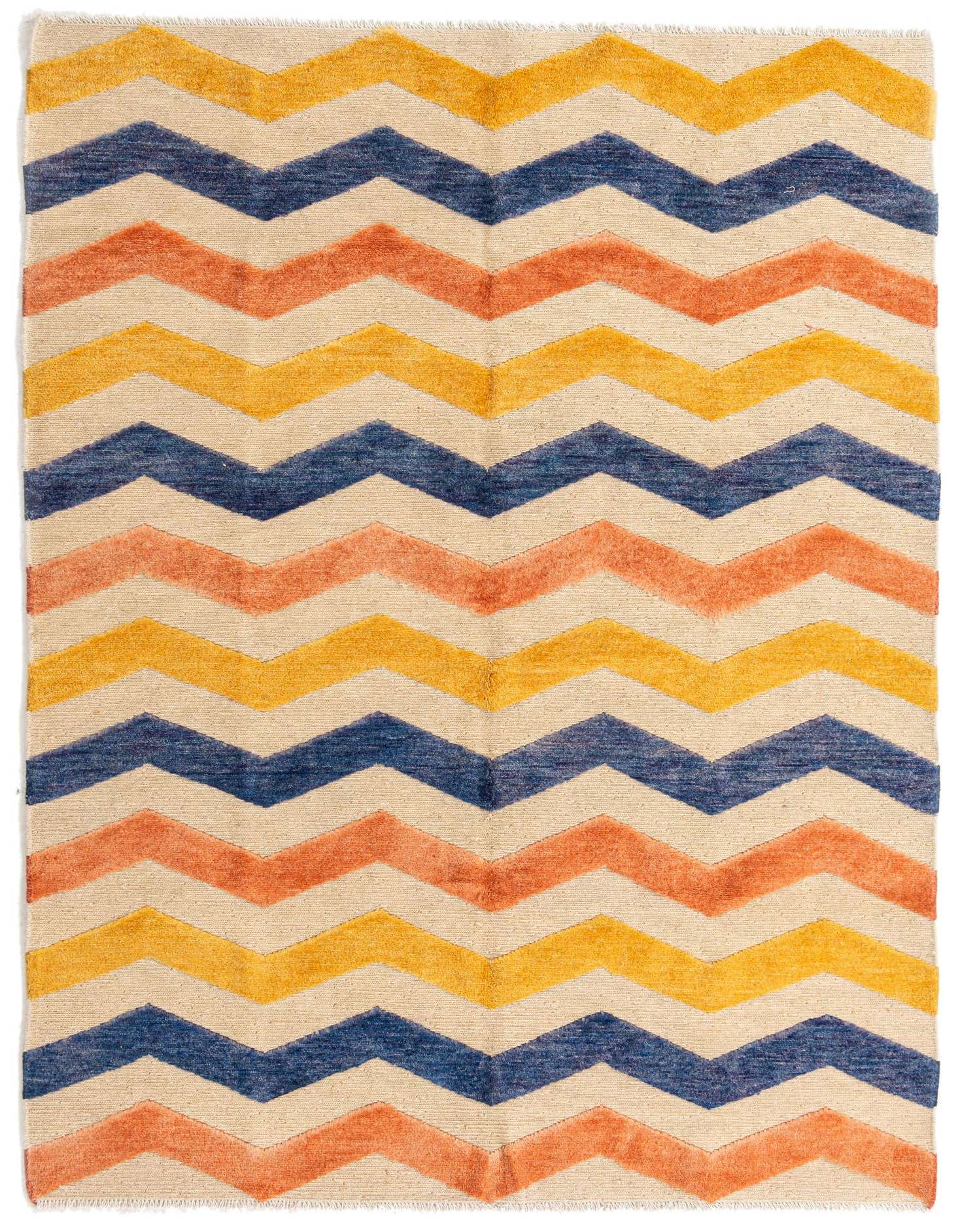 A 5x8 rectangular multi-colored tribal shag rug with a bold chevron pattern in cream, orange, yellow, and blue.