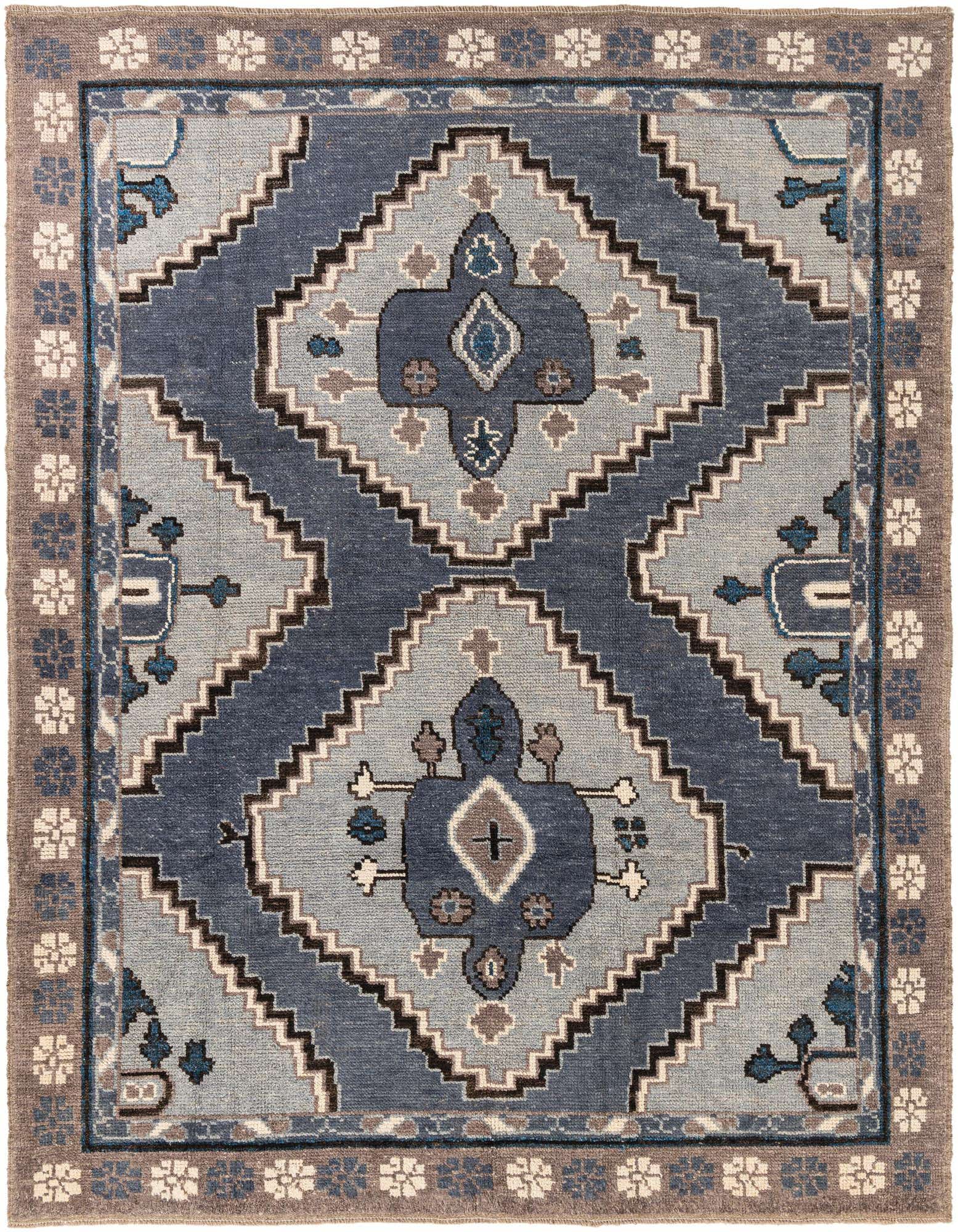 A rectangular 8x10 multi-colored wool shag rug with a tribal medallion pattern in shades of blue and brown.