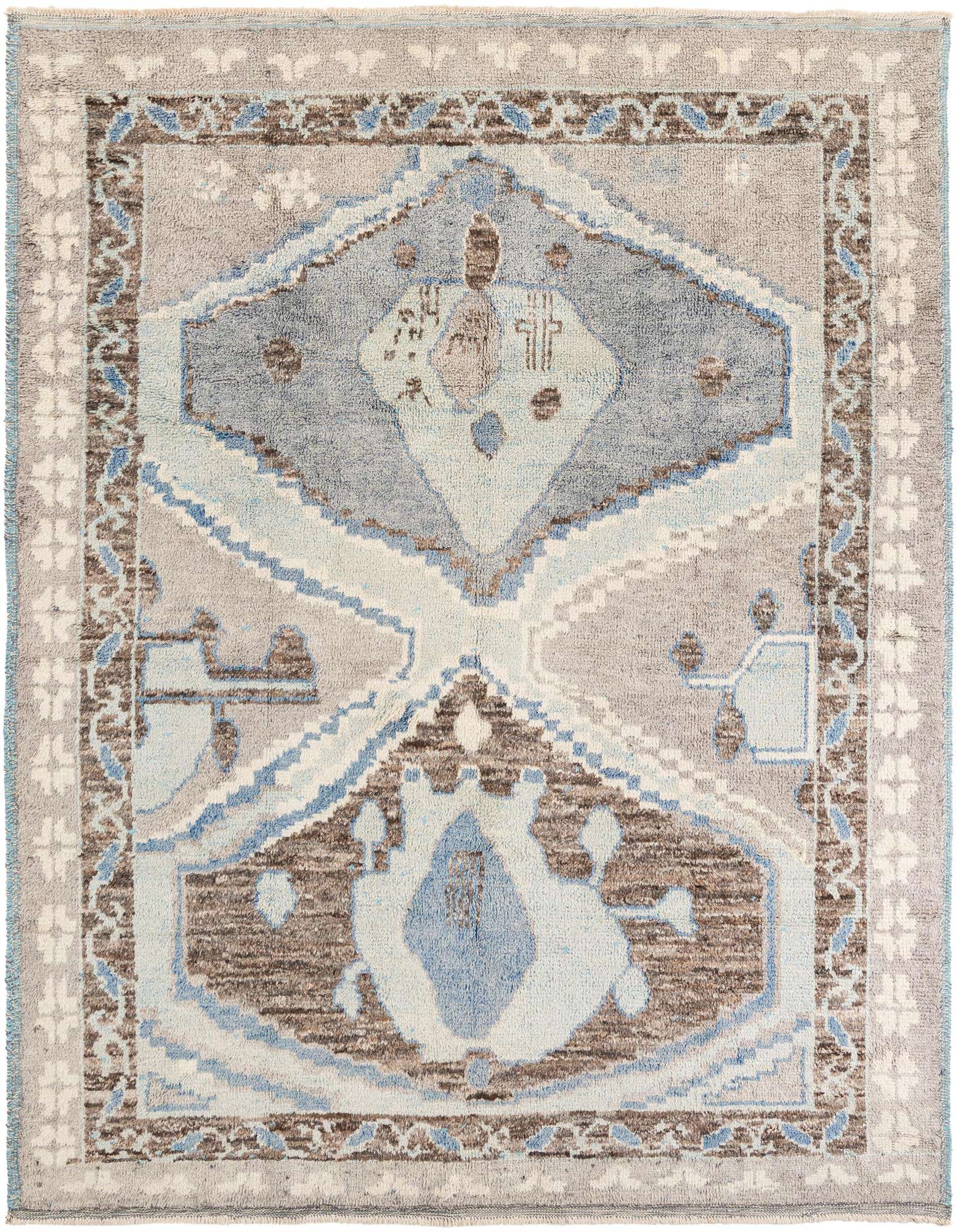 A rectangular 8x10 Moroccan shag rug with a multi-colored tribal medallion pattern in shades of blue, brown, and grey.