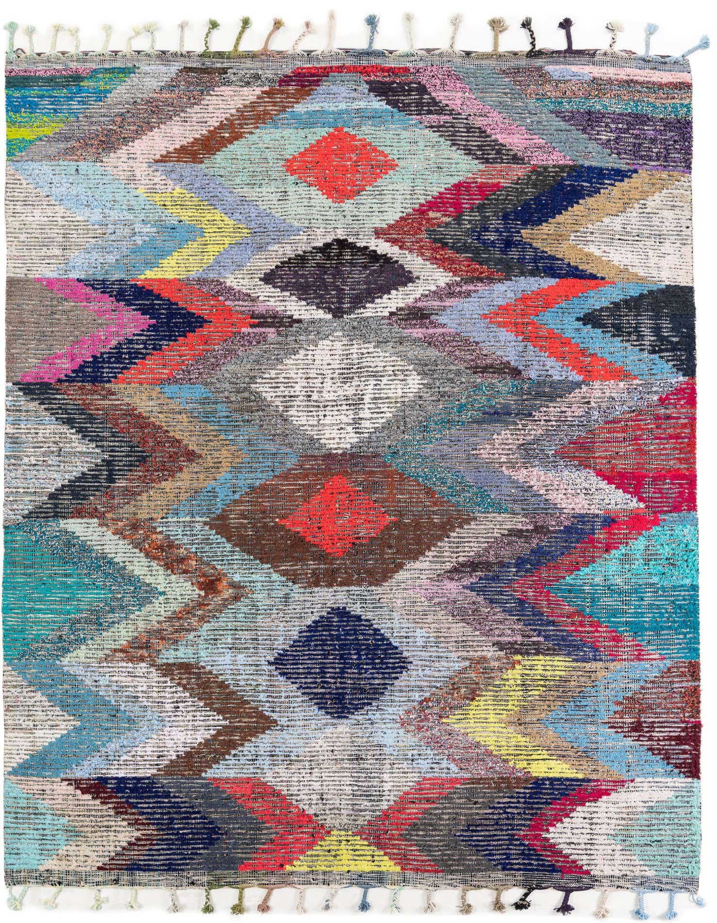 A vibrant 8x11 multi-colored rectangular shag rug featuring a bold tribal diamond and zigzag pattern with tassels.