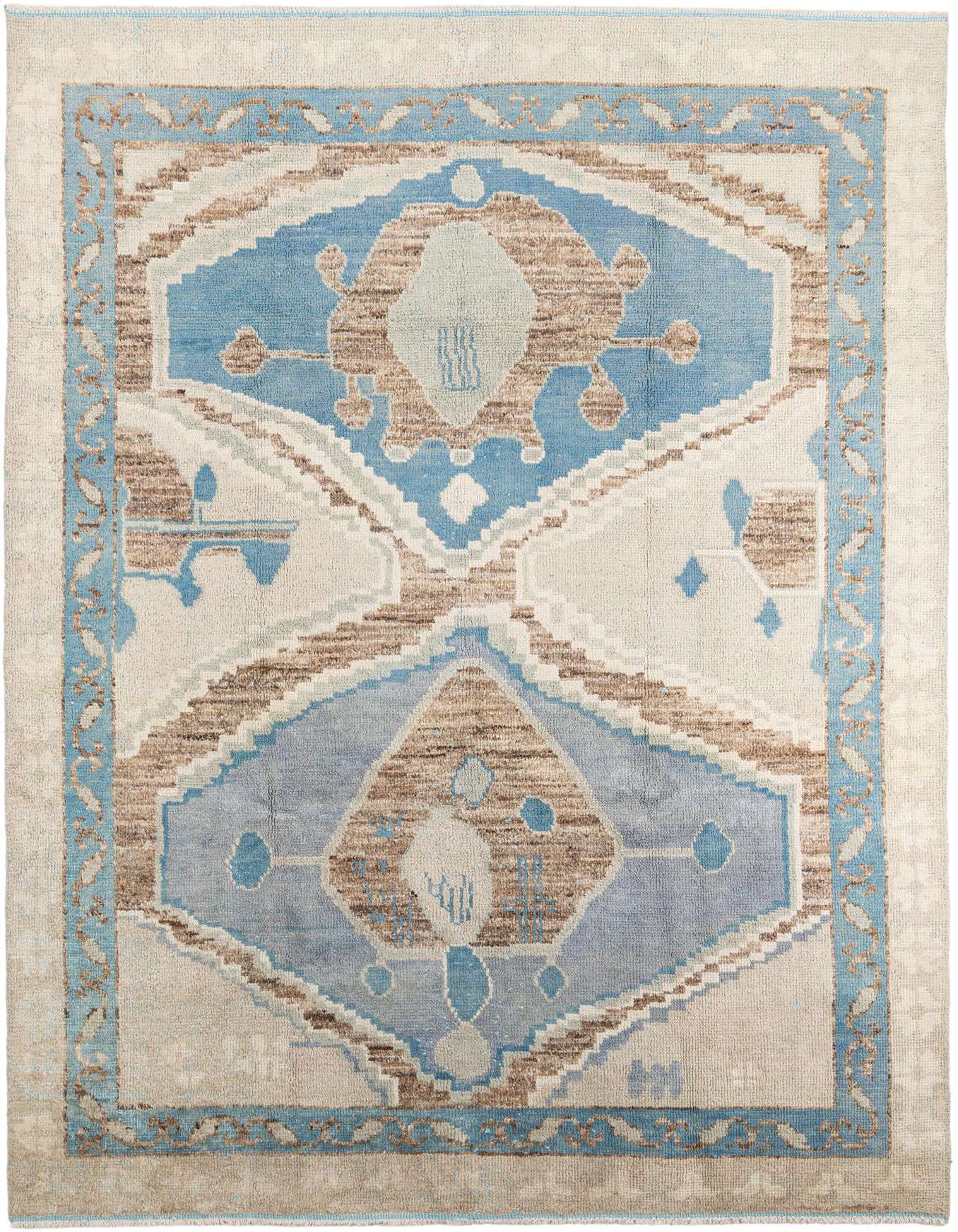 A 9x12 rectangular Moroccan shag rug with a multi-colored tribal medallion pattern in blues, browns, and cream.