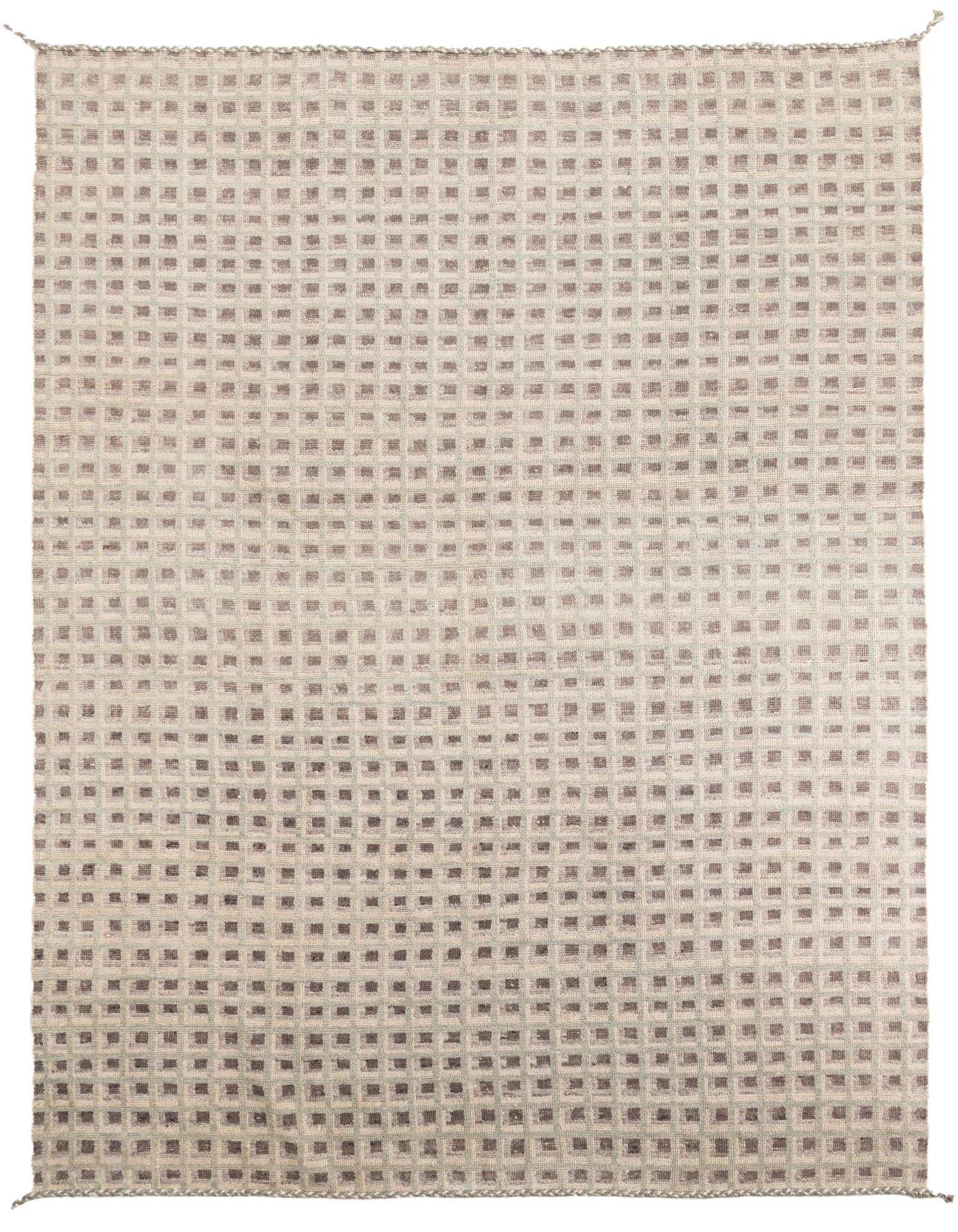 A 9x12 rectangular shag rug with a multi-colored tribal pattern, featuring small squares in varying shades of brown and beige.