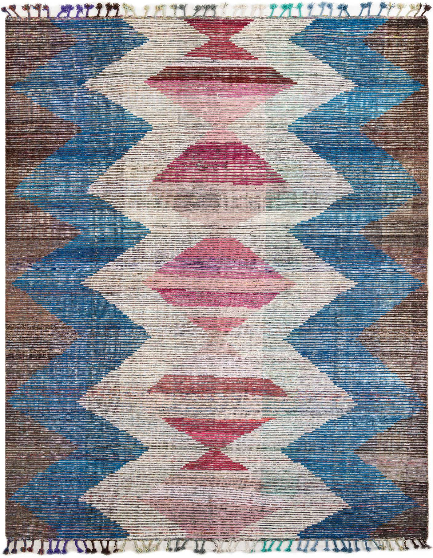 A 9x12 multi-colored rectangular shag rug with a bold tribal geometric pattern in blue, pink, and brown tones.