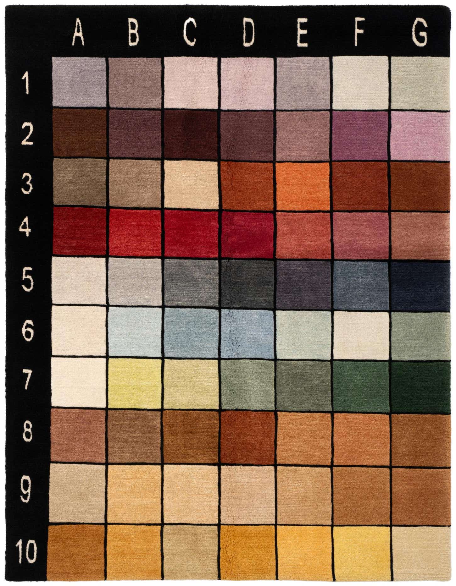 A 5x7 multi-colored wool rug with a modern grid pattern, featuring various shades of red, blue, green, brown, and beige squares.