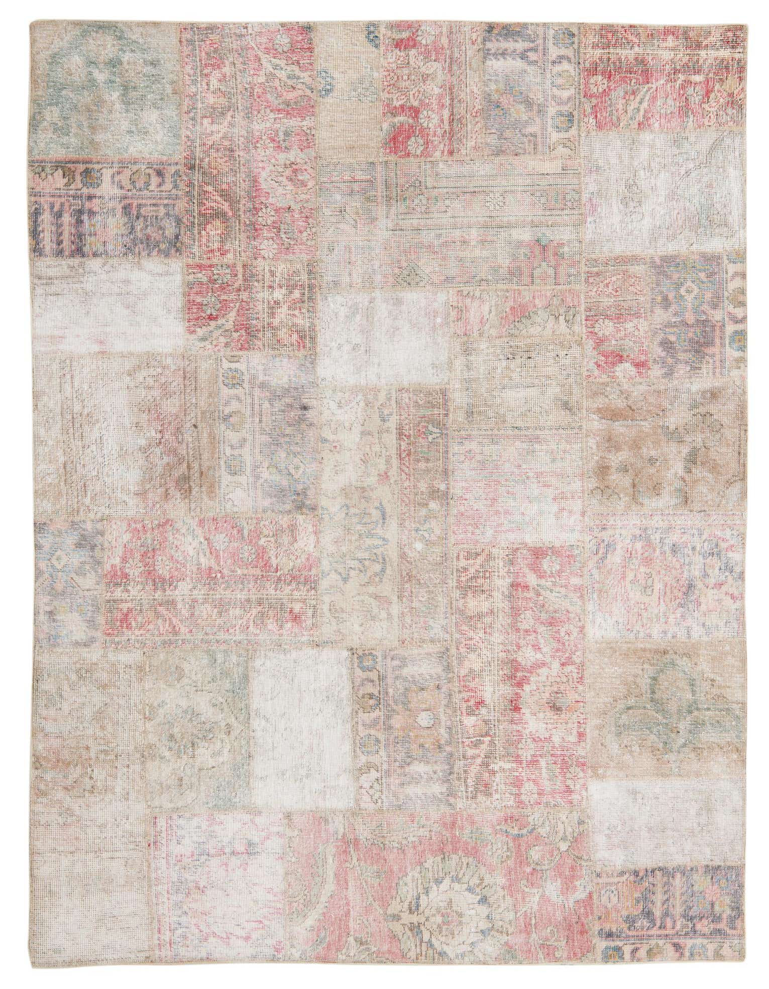A 5x8 rectangular multi-colored patchwork rug featuring distressed Persian and abstract patterns in various shades of red, beige, and green.