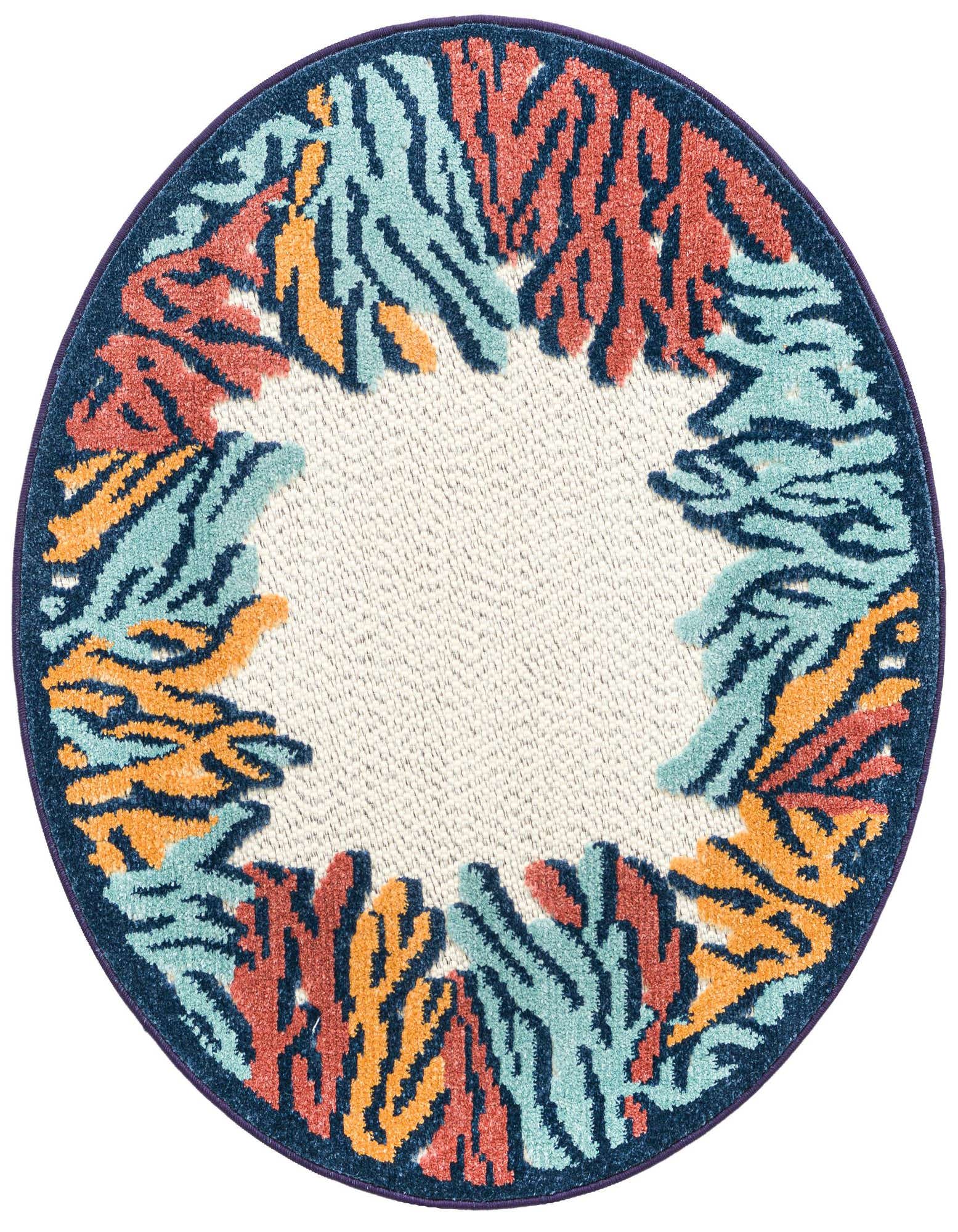 A round, multi-colored coastal rug featuring an abstract coral reef pattern in teal, orange, and red on a cream background with a navy border.