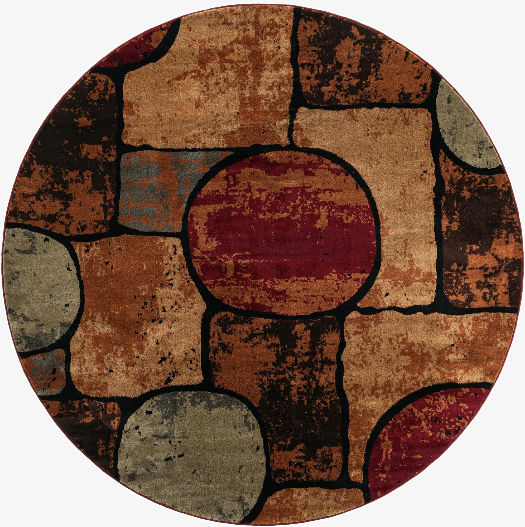 A round, multi-colored modern abstract rug featuring a mosaic of shapes in shades of red, brown, tan, and grey, outlined in black.