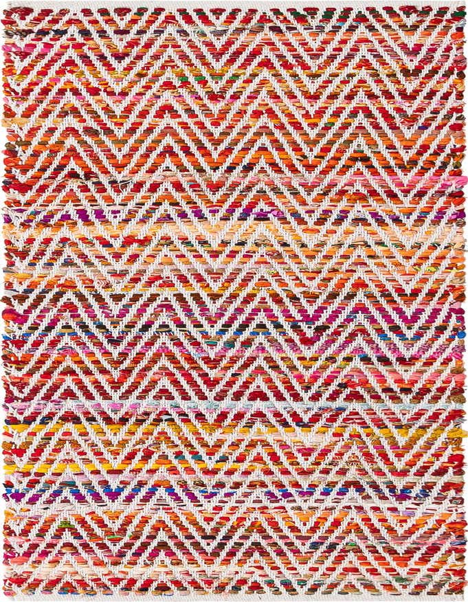 A 6 ft multi-colored Chindi Chevron runner rug with a vibrant zigzag pattern, perfect for a hallway.