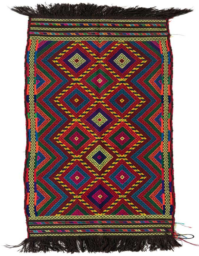 A vibrant, multi-colored 9 ft runner rug with a tribal geometric pattern and dark fringe, ideal for a hallway.