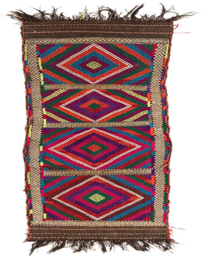 A vibrant 8 ft runner rug with a multi-colored geometric diamond pattern and tribal accents, ideal for a hallway.