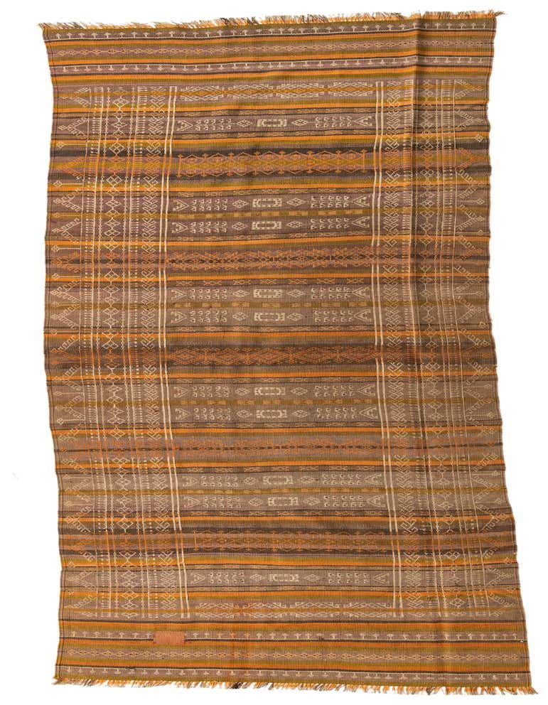 A 12 ft Kilim Fars runner rug with multi-colored stripes and tribal patterns, perfect for a hallway.