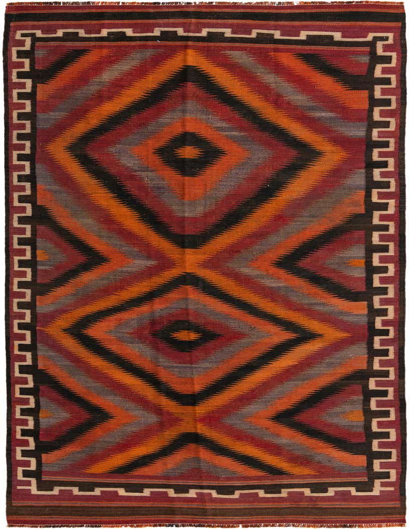 A 12 ft runner rug, the Kilim Fars features a multi-colored tribal pattern with large diamonds in orange, red, black, and gray, bordered by a stepped design.