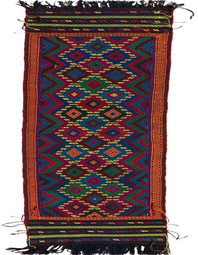 A vibrant 9 ft runner rug with a multi-colored geometric tribal pattern, featuring shades of red, blue, green, and yellow on a dark background, with orange borders and black fringe.