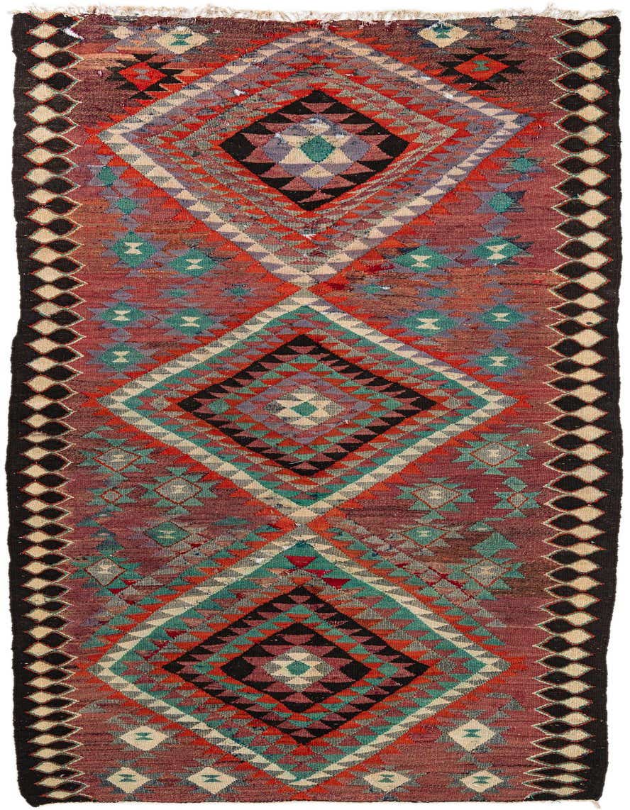 A 10 ft multi-colored runner rug featuring a vibrant tribal pattern with large geometric diamonds in red, teal, black, and cream.