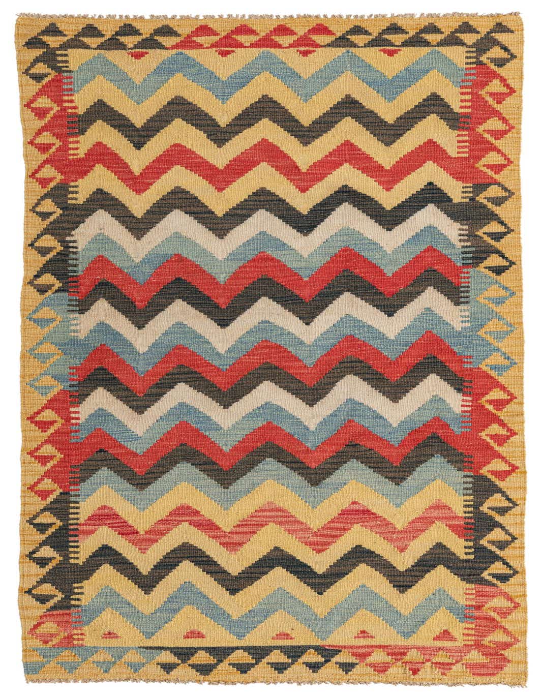 A multi-colored 6 ft runner rug with a bold zigzag pattern in red, blue, black, and cream, framed by a yellow border with tribal motifs.