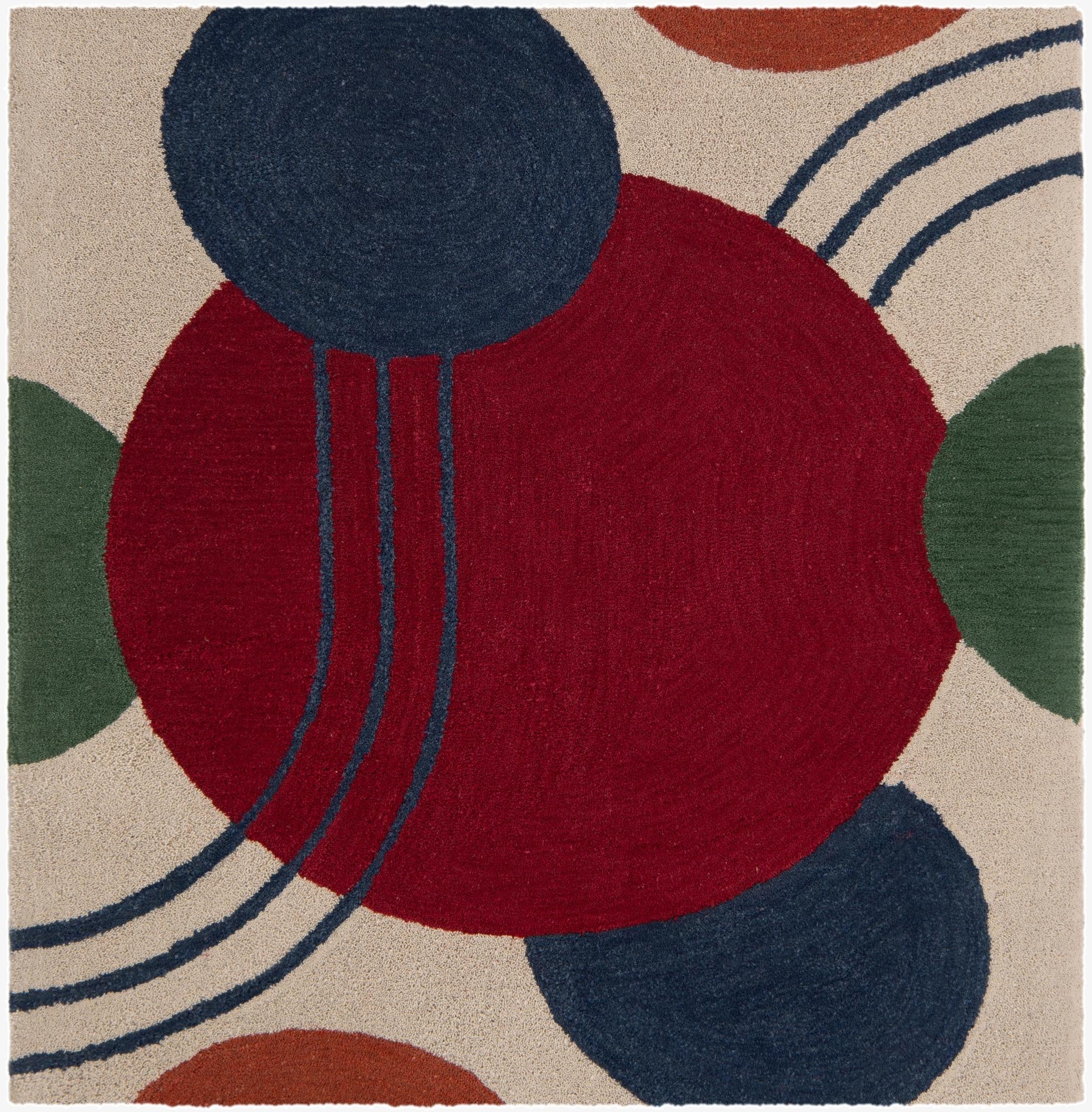 A square, multi-colored wool rug featuring large red, blue, green, and rust circles and curved lines on a cream background.