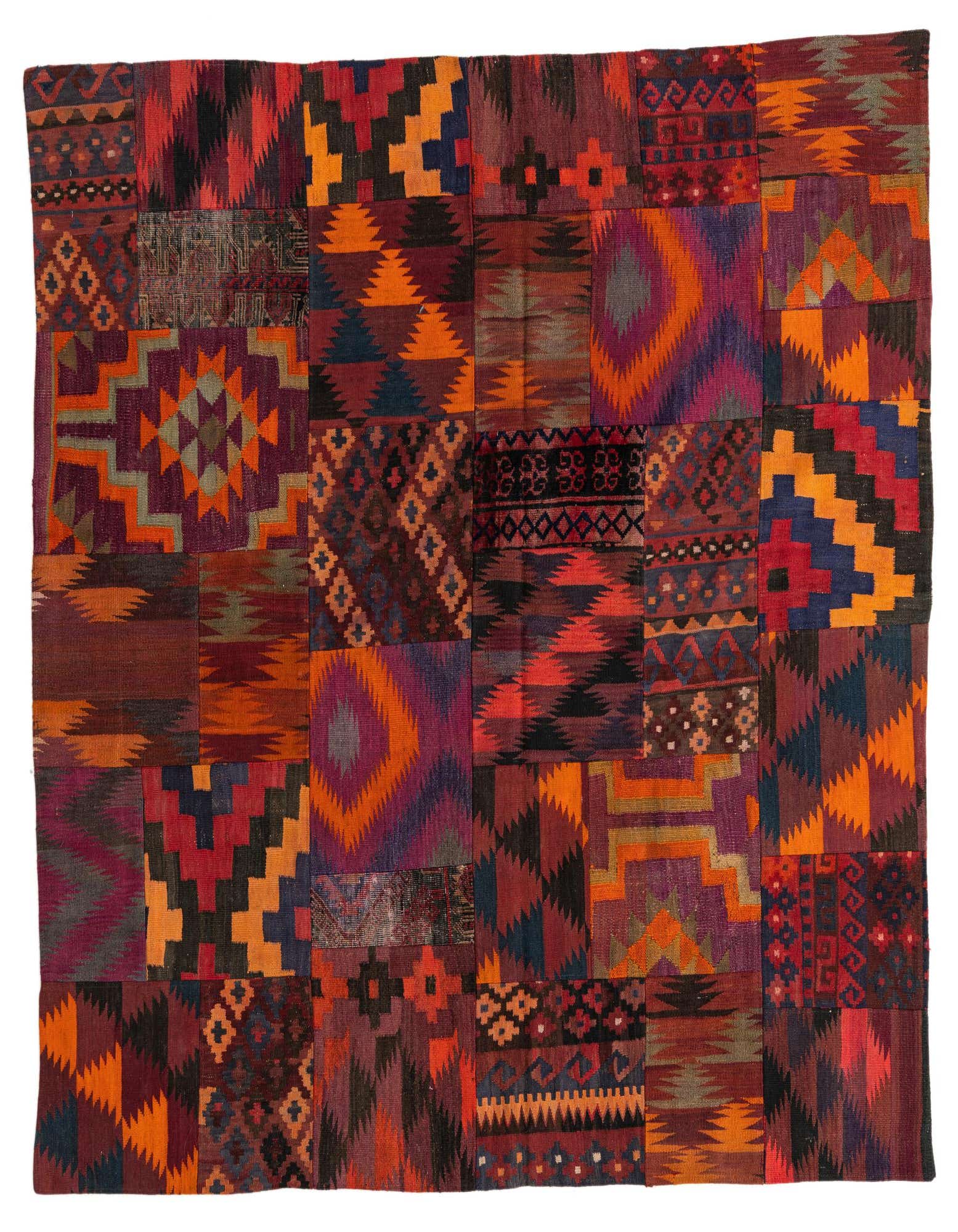 A square, multi-colored Kilim Patchwork rug featuring various Southwestern and tribal patterns in shades of red, orange, purple, and blue.