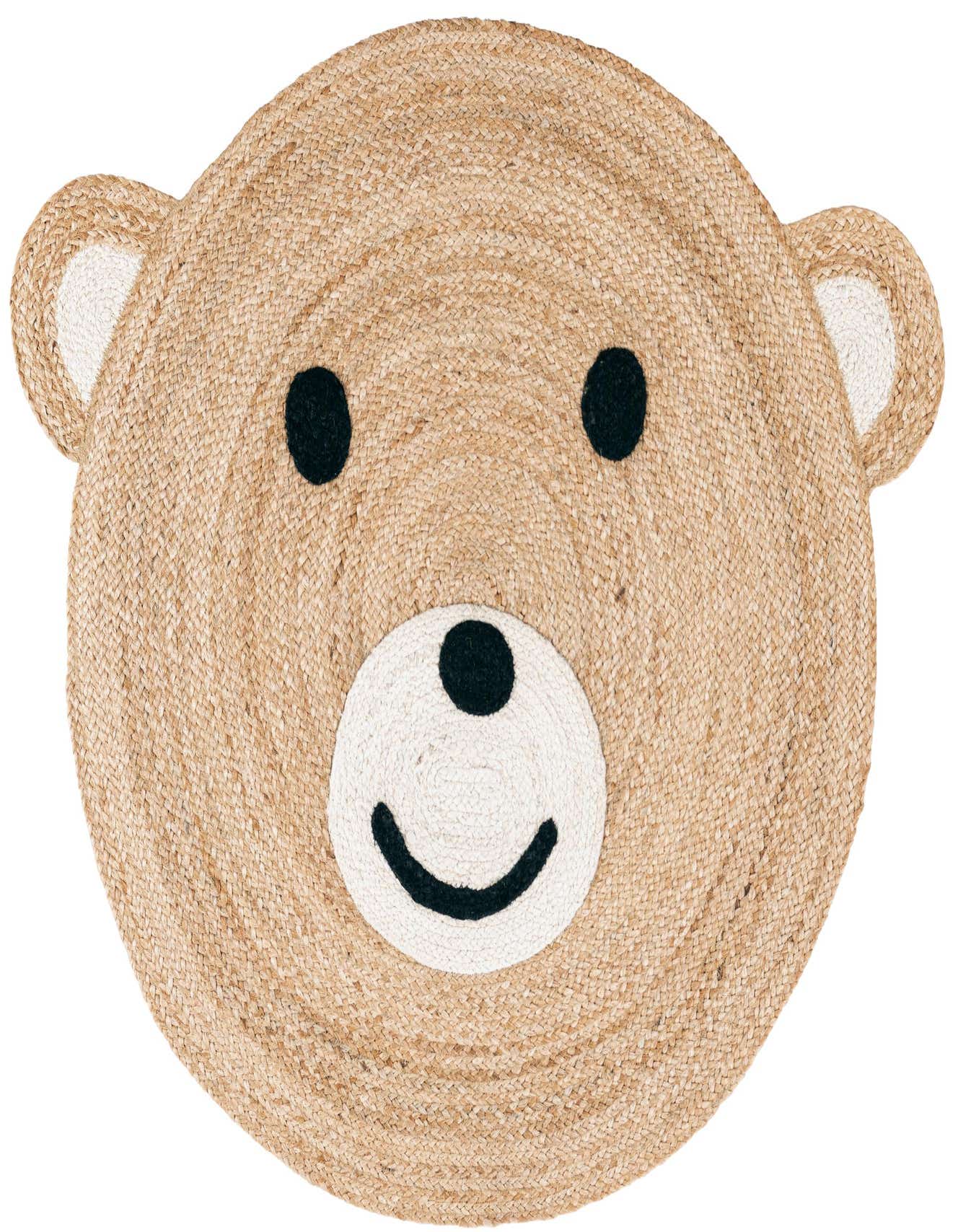 A round, braided jute rug shaped like a friendly brown bear face with white inner ears and snout, and black eyes and smile.
